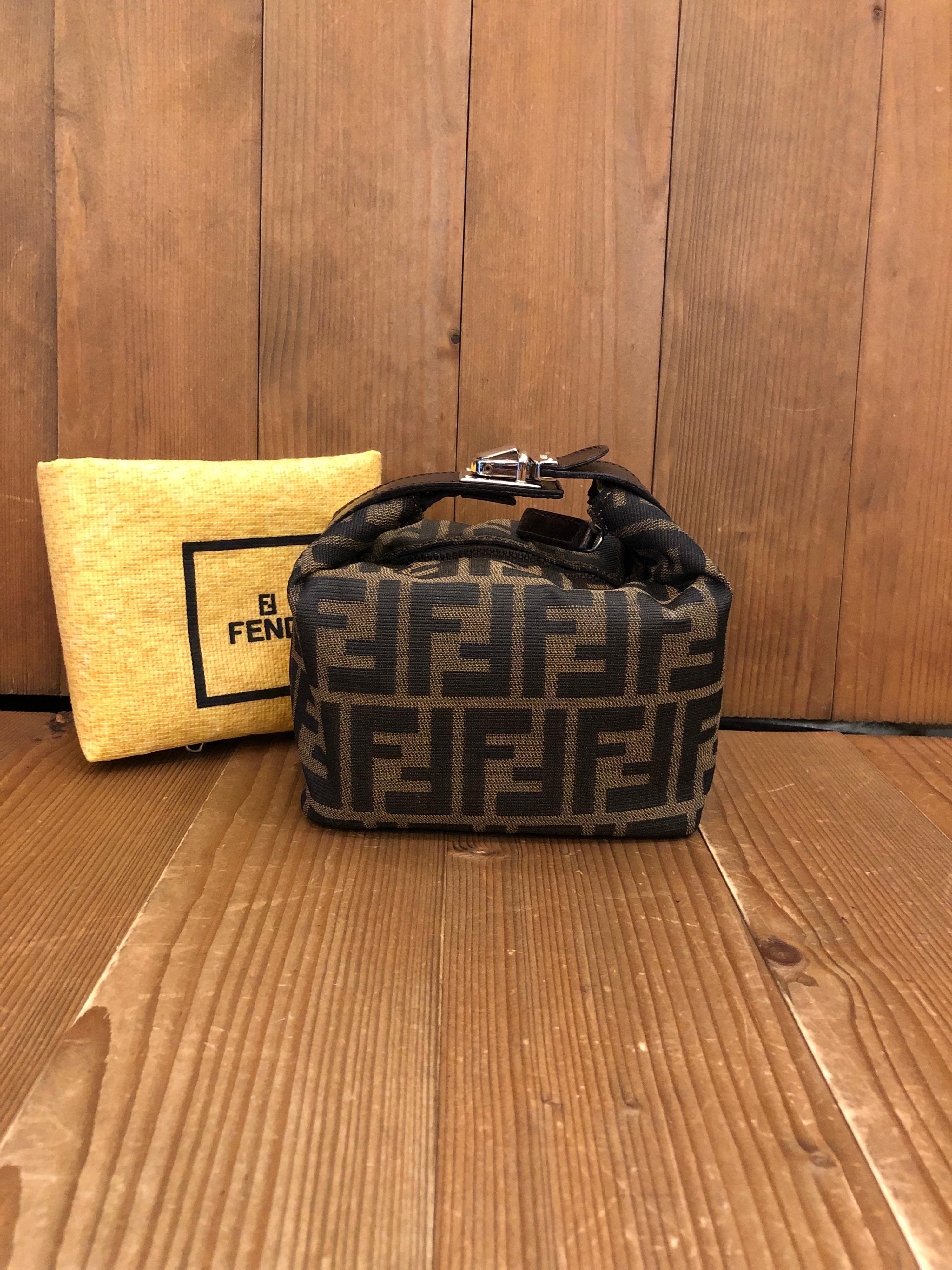 Vintage Fendi mini vanity pouch in Fendi's iconic Zucca jacquard featuring silver toned buckled handle. Made in Italy. Measures 6 x 5 x 3.75 inches (fits plus-sized iPhone). Comes with dust bag.

Condition: Minor signs of wear with interior fully
