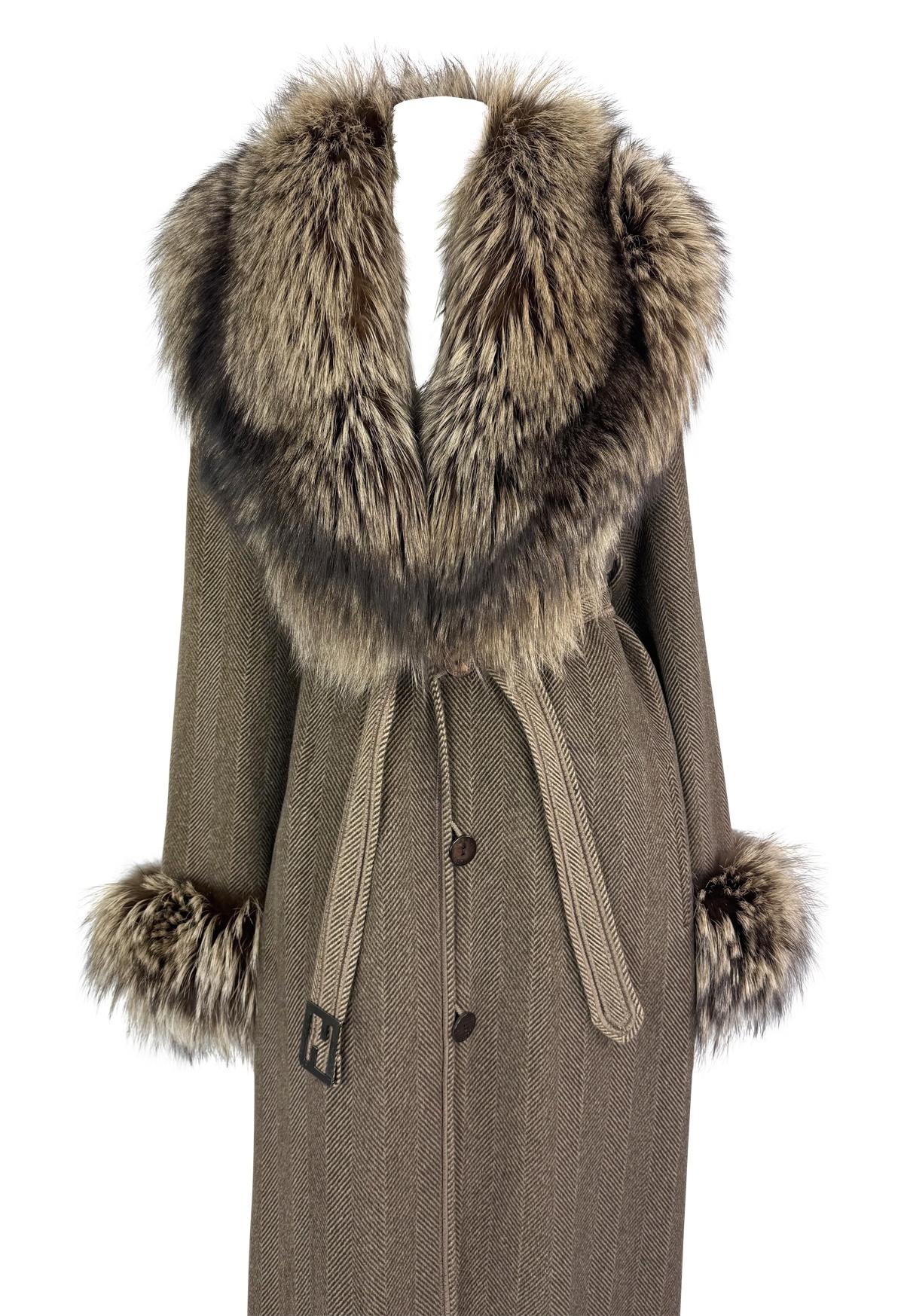This brown herringbone coat from 1990s Fendi by Karl Lagerfeld features fox fur trim on the oversized shawl collar and cuffs. The design is finished with a belted waist and the signature FF logo buckle.

Approximate measurements:
Size -