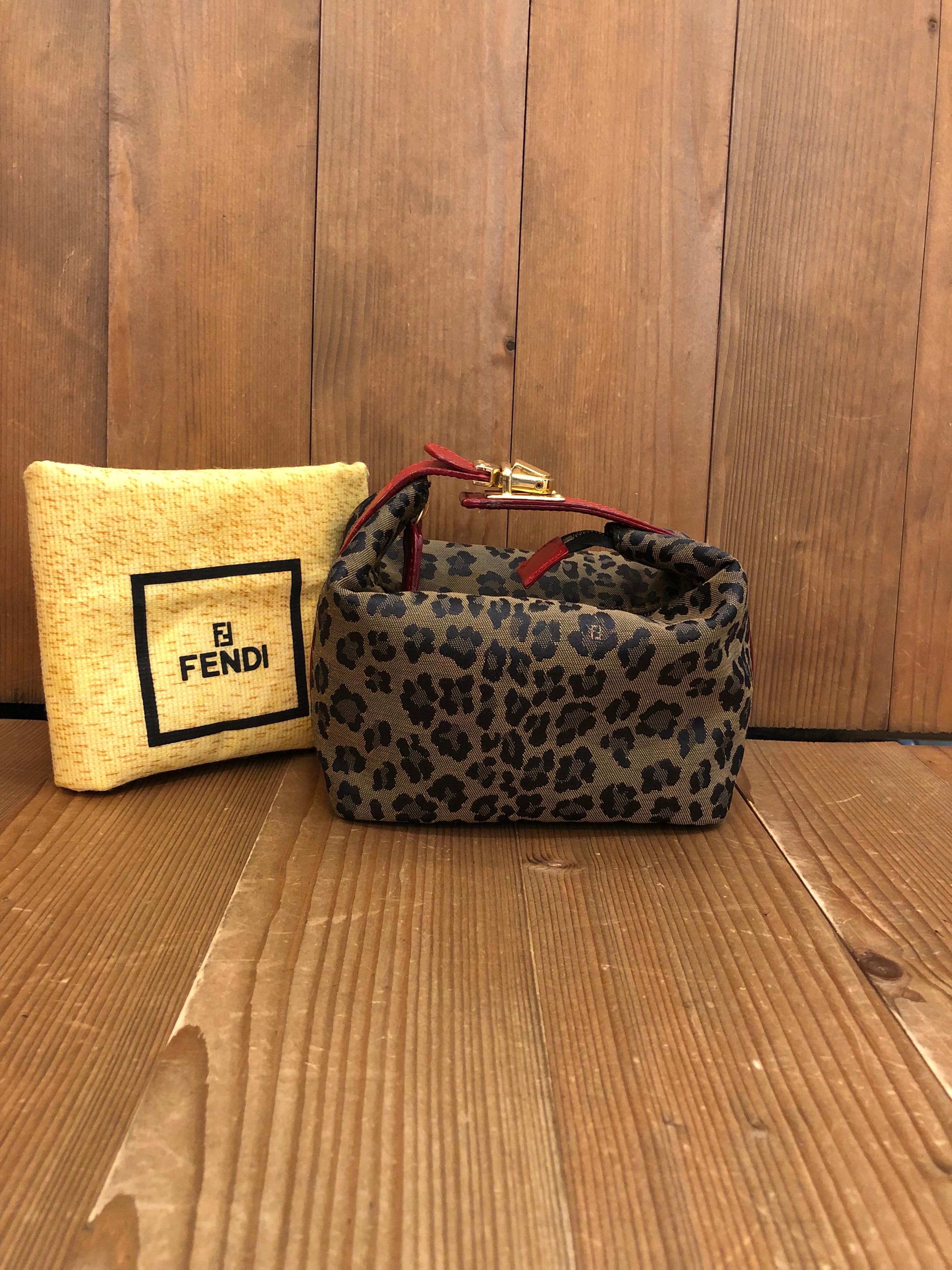 1990s Fendi mini vanity pouch in Fendi's leopard jacquard featuring gold toned buckled handle. Made in Italy. Measures 5.75 x 4 x 3.75 inches (fits plus-sized iPhone). Comes with dustbag.

Condition: Minor signs of wear. Generally in good