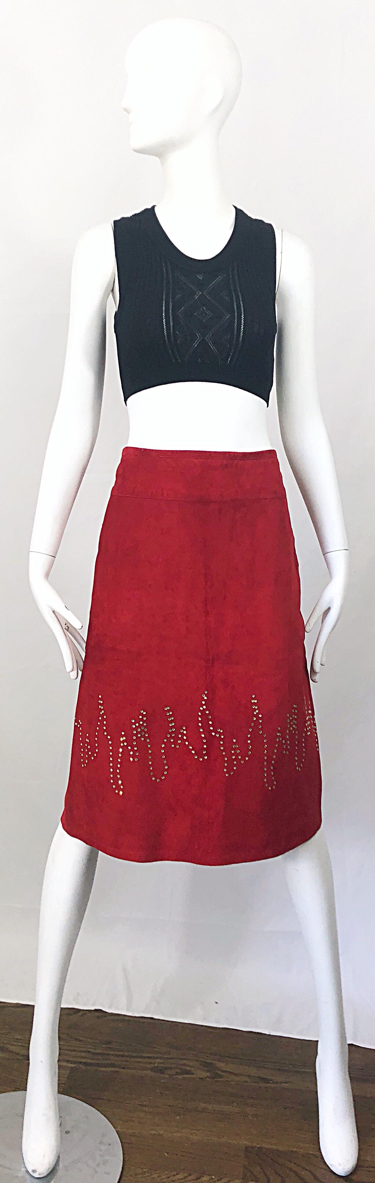 Chic late 1990s fire engine red suede + rhinestones 'flames' skirt! Features hundreds of hand-sewn rhinestones in the shapes of flames. Fully lined in silk printed with navy blue and purple polka dots. Hidden zipper up the side with button closure.