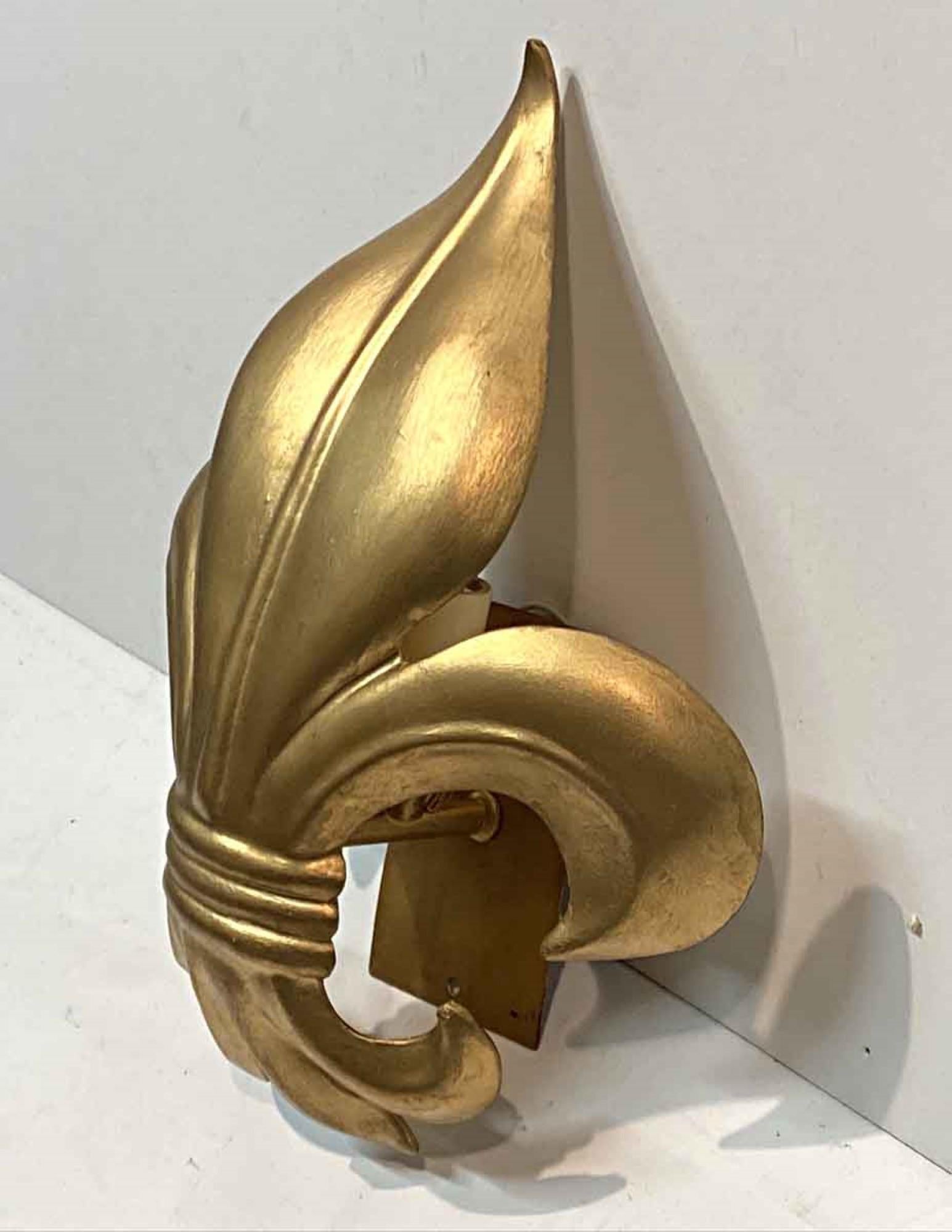 1990s fleur-de-lis single light wall sconce featuring a gold leaf finish. Cleaned and rewired. Small quantity available at time of posting. Priced each. Please inquire. Please note, this item is located in our Scranton, PA location.
