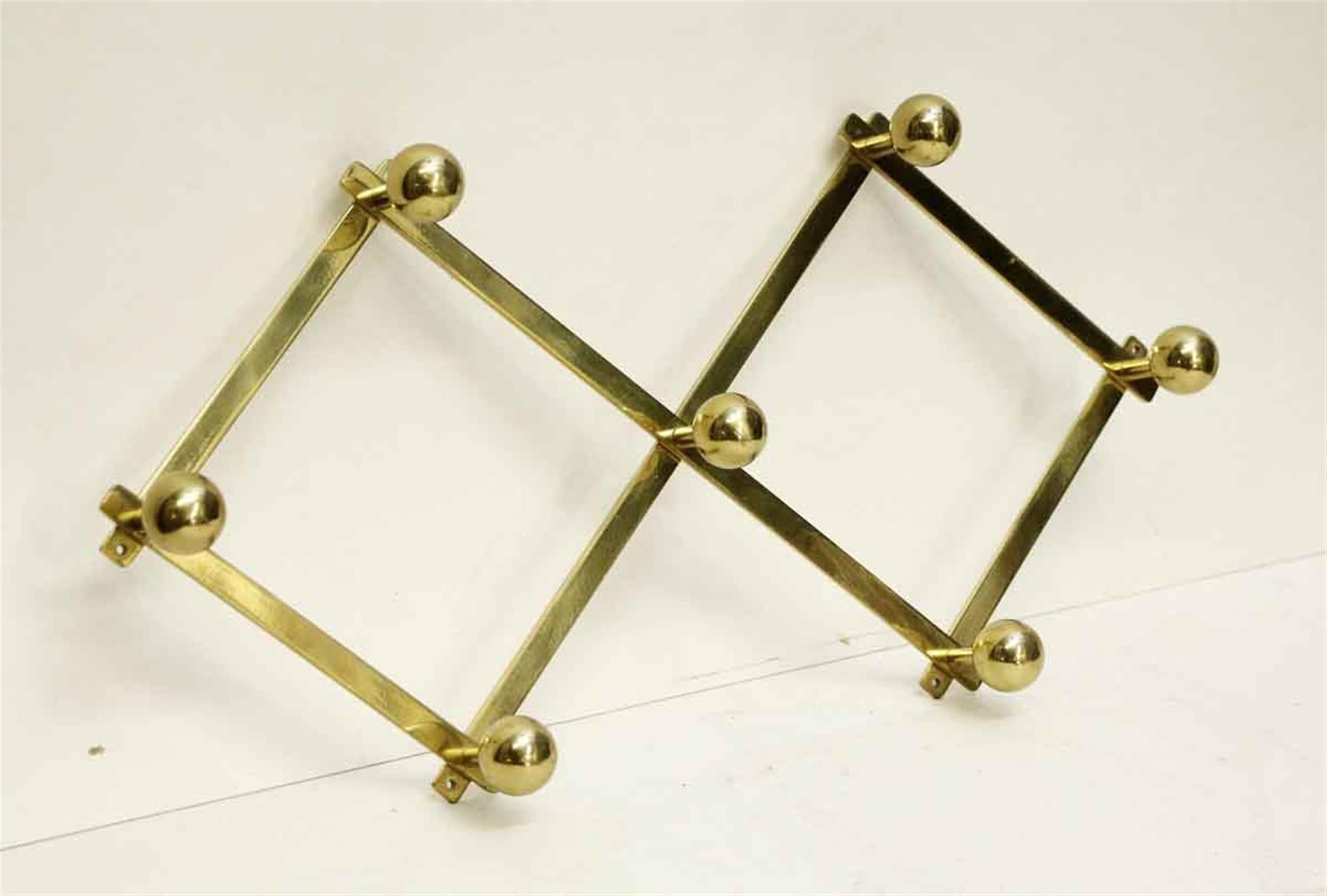 1990s polished brass accordion shaped hook rack with seven ball hooks. This can be seen at our 2420 Broadway location on the upper west side in Manhattan.