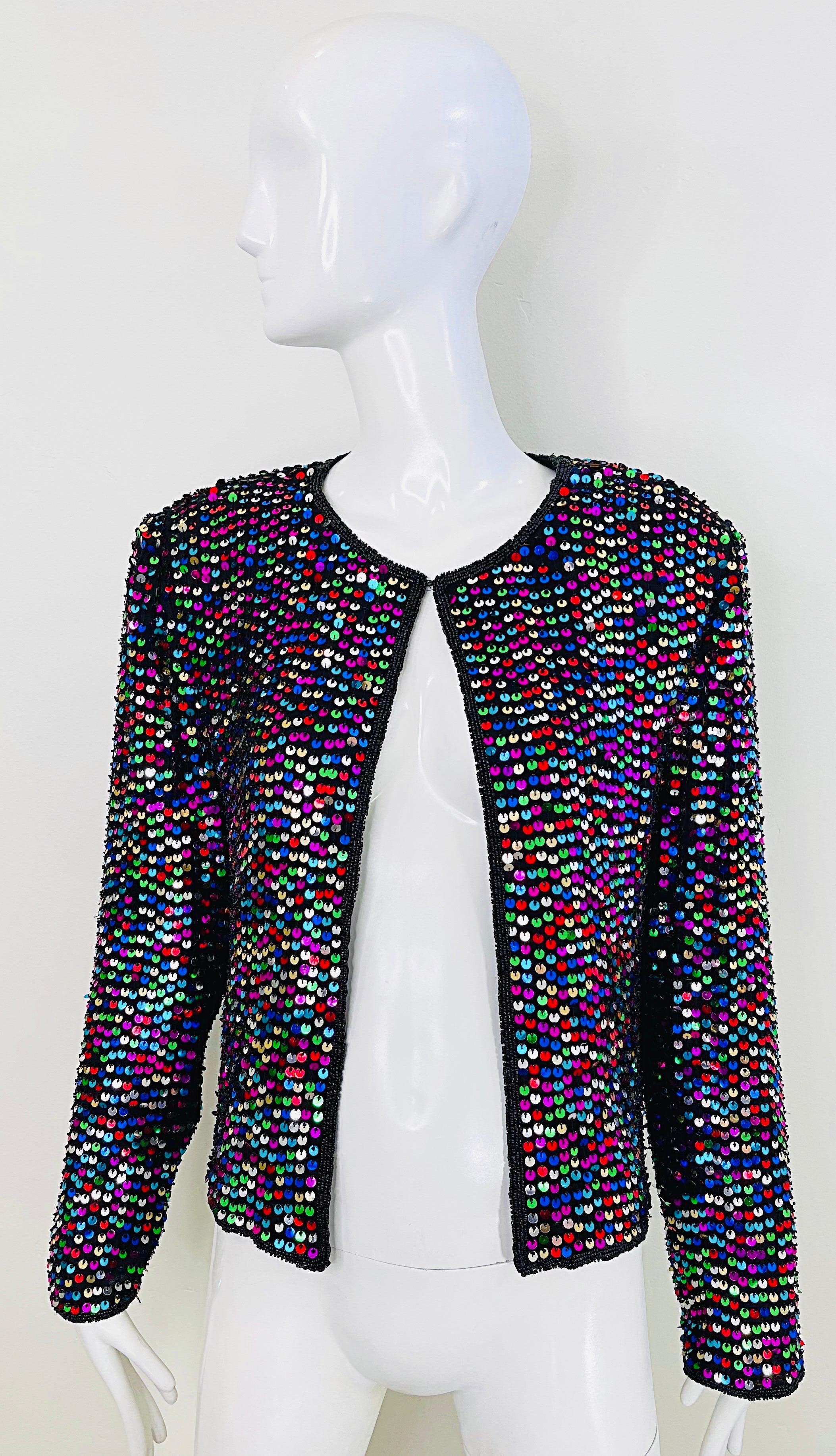 Amazing 1990s fully sequined and beaded colorful silk cardigan ! Features thousands of hand-sewn sequins in purple, green, blue, red, gold and silver throughout. Black seed beads trim the edges. Hook-and-eye closure at top center neck. Fully