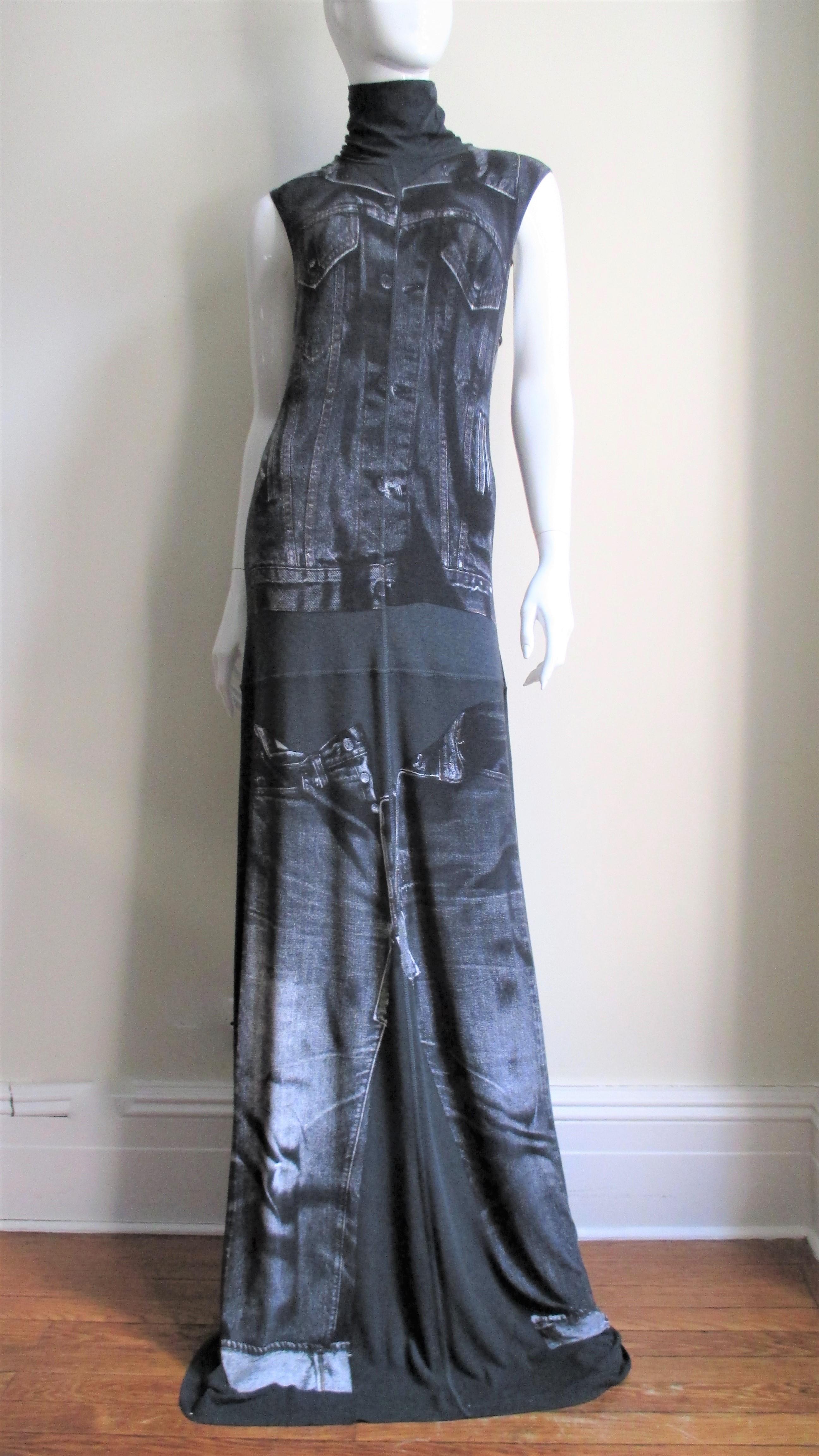 A great maxi dress from Jean Paul Gaultier in a black jersey with a trompe l'oeil jean jacket and jeans screen printed on the front and back.  It has a stand up collar and skims the body then flares to the hem.  It comes with fabulous separate