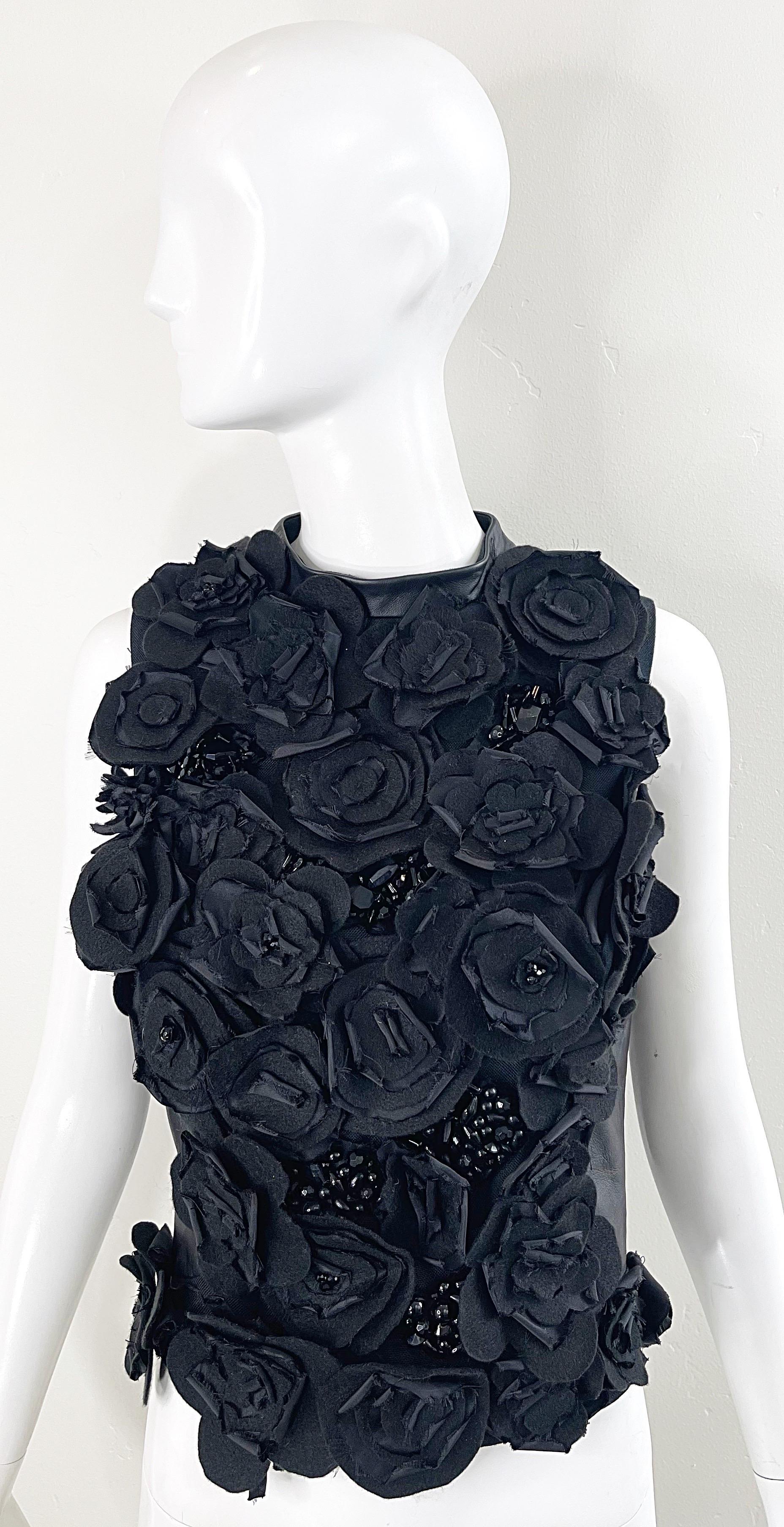 Amazing and rare 1990s GEMMA KAHNG black leather and silk flower appliqué beaded sleeveless top ! Features hundreds of hand-sewn felts flowers with black rhinestones and beads throughout. Leather back with full zip up the entire back. Can easily be