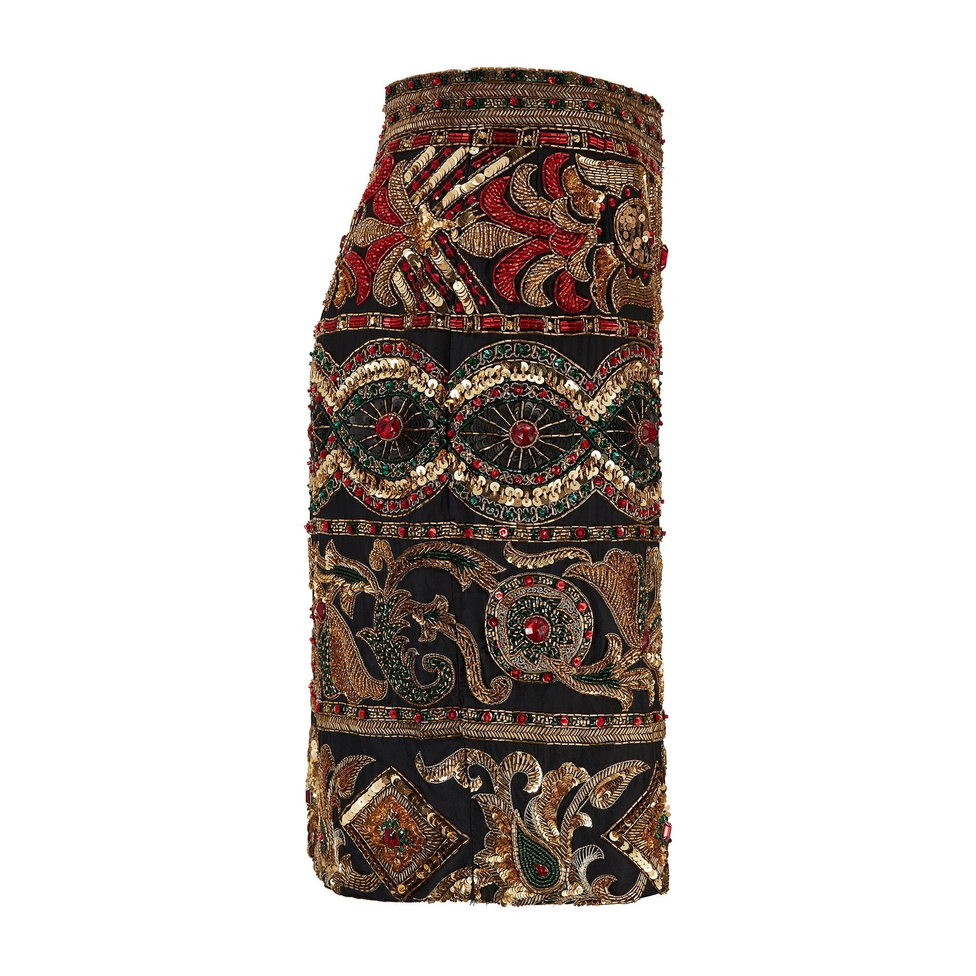 This magnificently ornate skirt was most likely designed by Gianni Versace and created by Italian ready-to-wear manufacturer Genny. Versace became the Creative Director at Genny in 1973 and remained there until the early 1990s. We have found a very