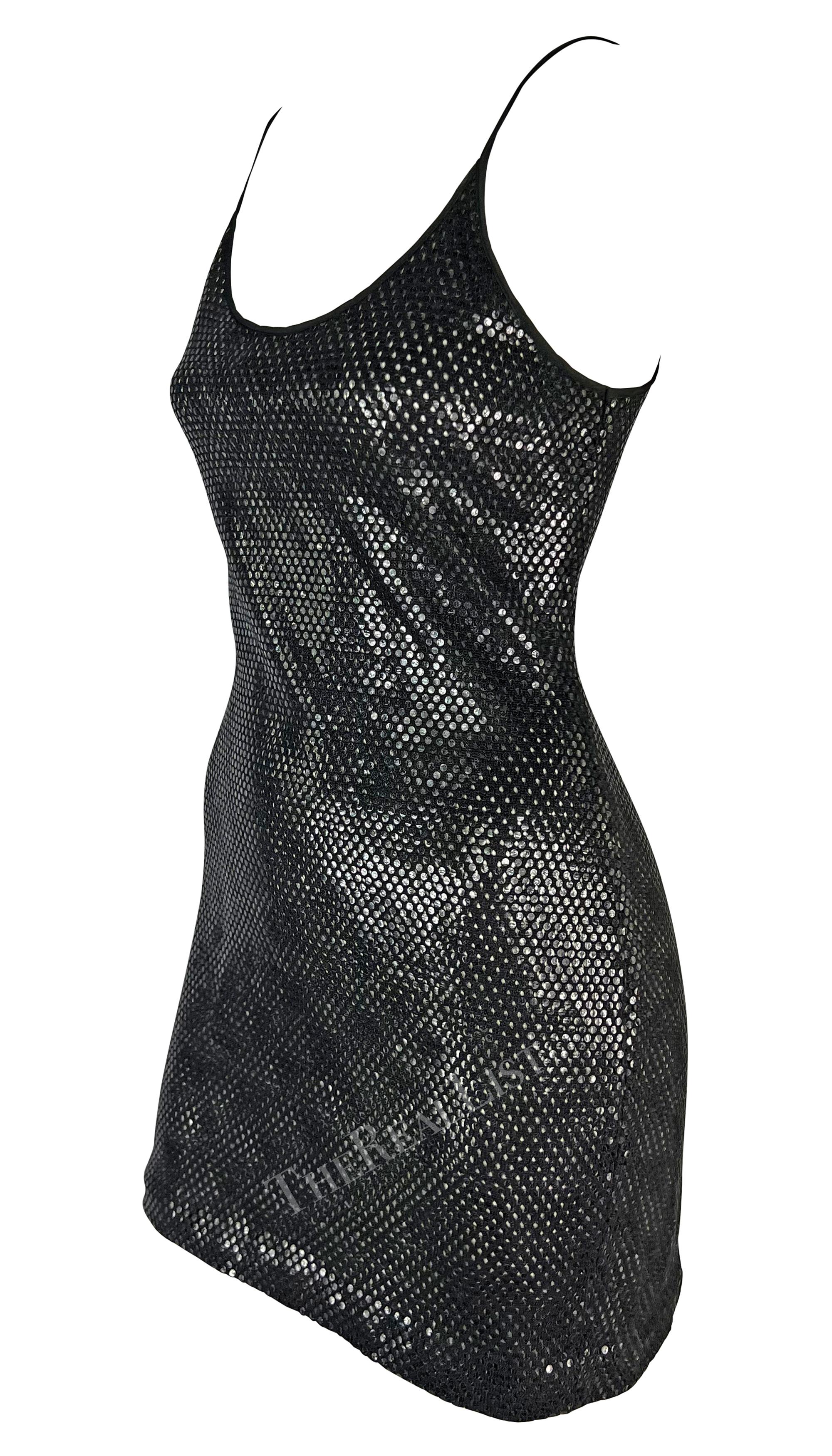 Presenting a stunning black metallic Gianfranco Ferre mini dress. From the 1990s, this mini slip dress, featuring a scoop neckline and thin spaghetti straps, shines with a lightweight eyelet black base covered in transparent round paillettes. Sexy