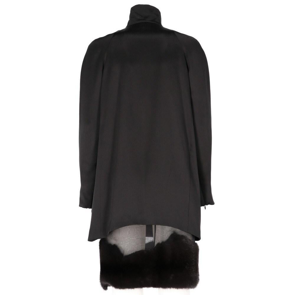 Gianfranco Ferré black silk suit, featuring a top and a skirt. Turtleneck top with frontal concealed zip, full-length sleeves zip. Silk skirt with mink edge, central back zip.

Size: 40 IT

Flat measurements

Top
Height: 76 cm
Bust: 47 cm
Shoulders: