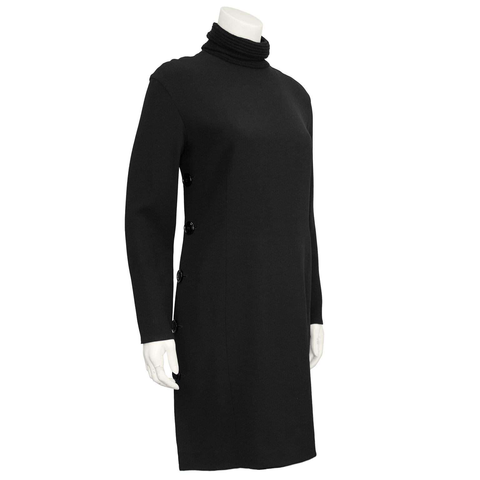 Gianfranco Ferre wool crepe LBD from the 1990s. Shift style with long sleeves and a knitted ribbed wool turtleneck. Large round black buttons down both side seams. Zipper closure up centre back. The dress can easily go from day to night with a quick