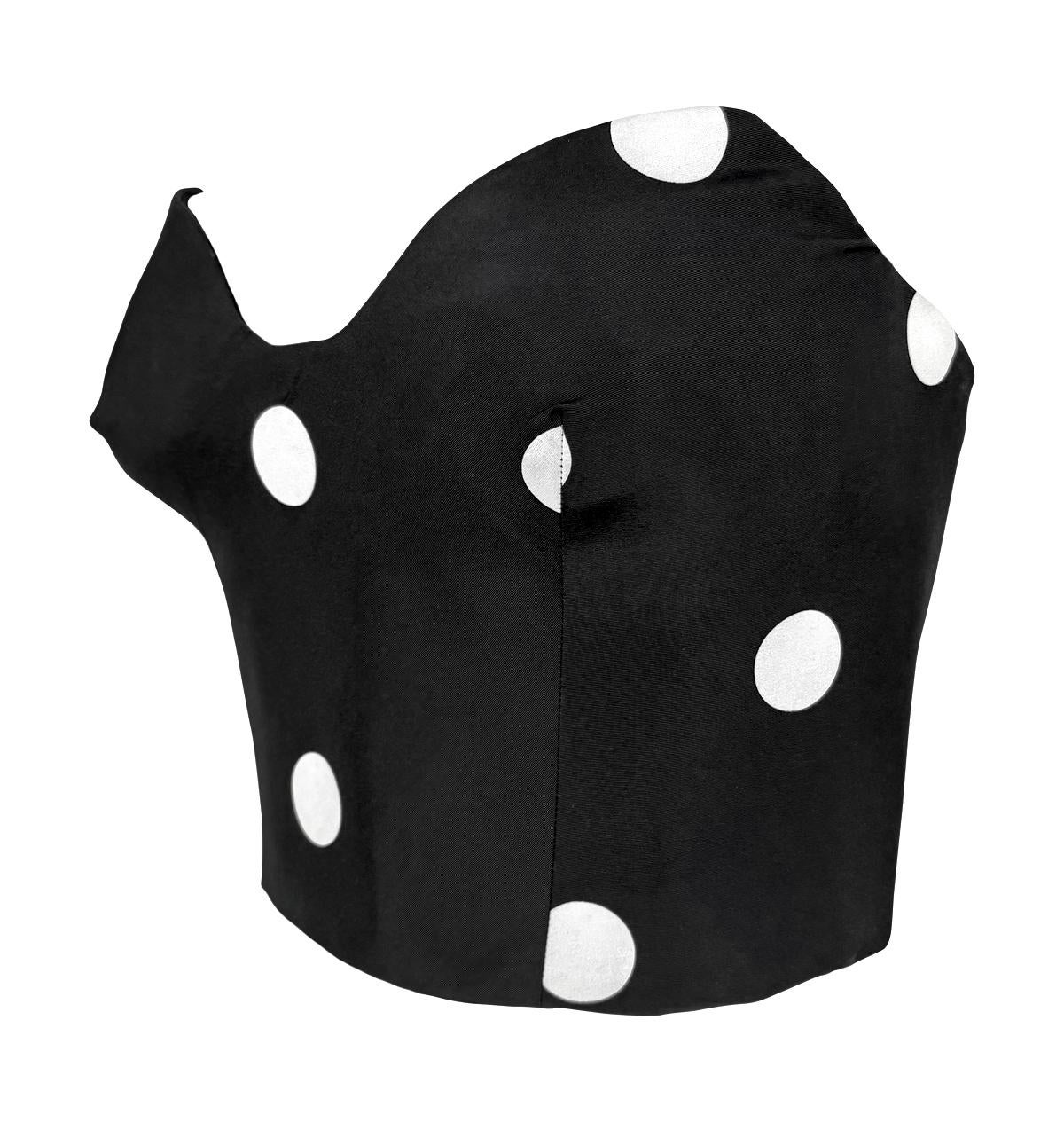From the 1990s, this Gianfranco Ferré black strapless bustier top features a bold white polka dot pattern in silk taffeta. Designed with internal boning for a sculpted silhouette, the bustier-style top is slightly cropped and complete with a