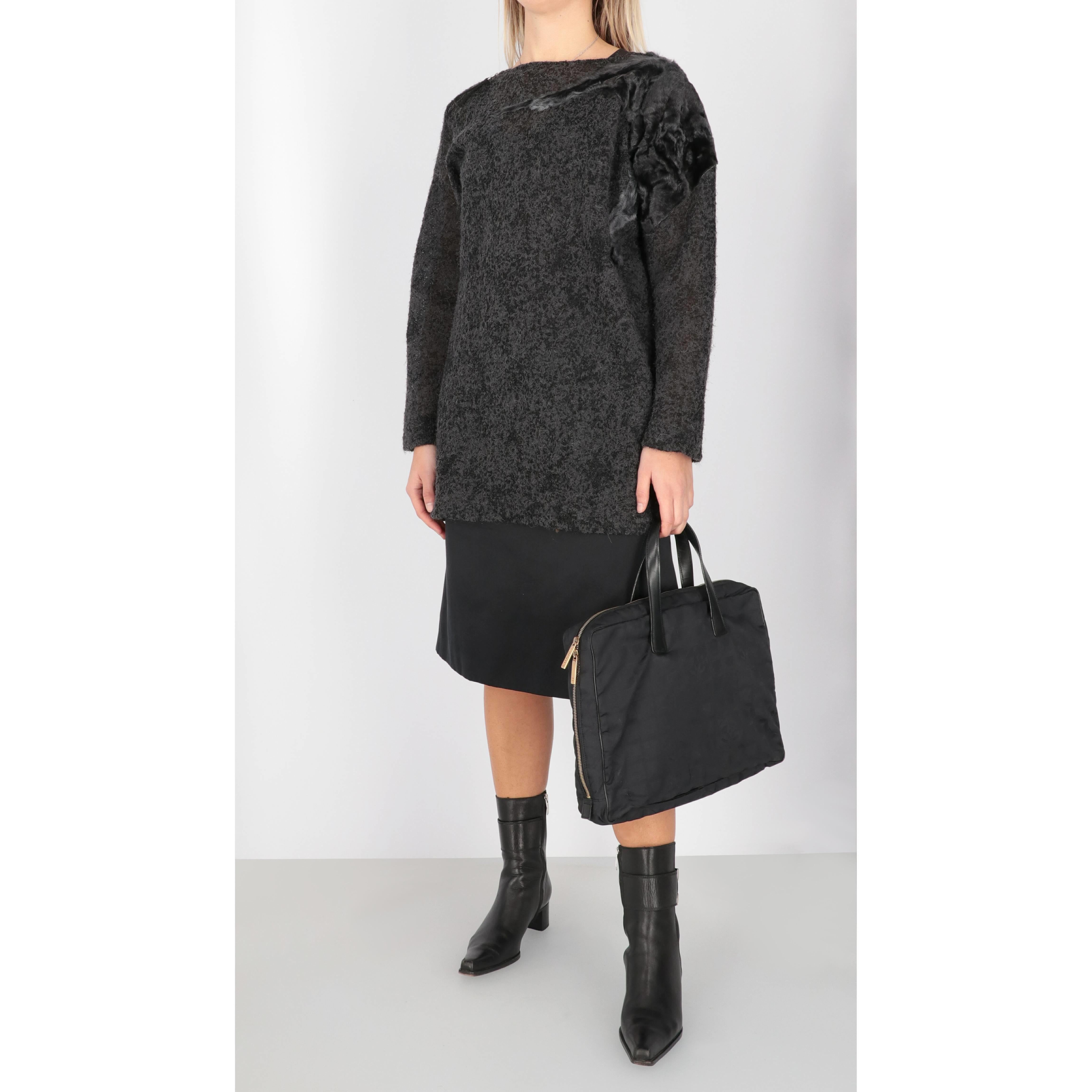Gianfranco Ferré alpaca, mohair and wool blend dark gray sweater with tone-on-tone lamb fur details. Crewneck model, with long sleeves, zip on the right shoulder with black leather puller and side slit on the bottom. Black silk tank top.

This item
