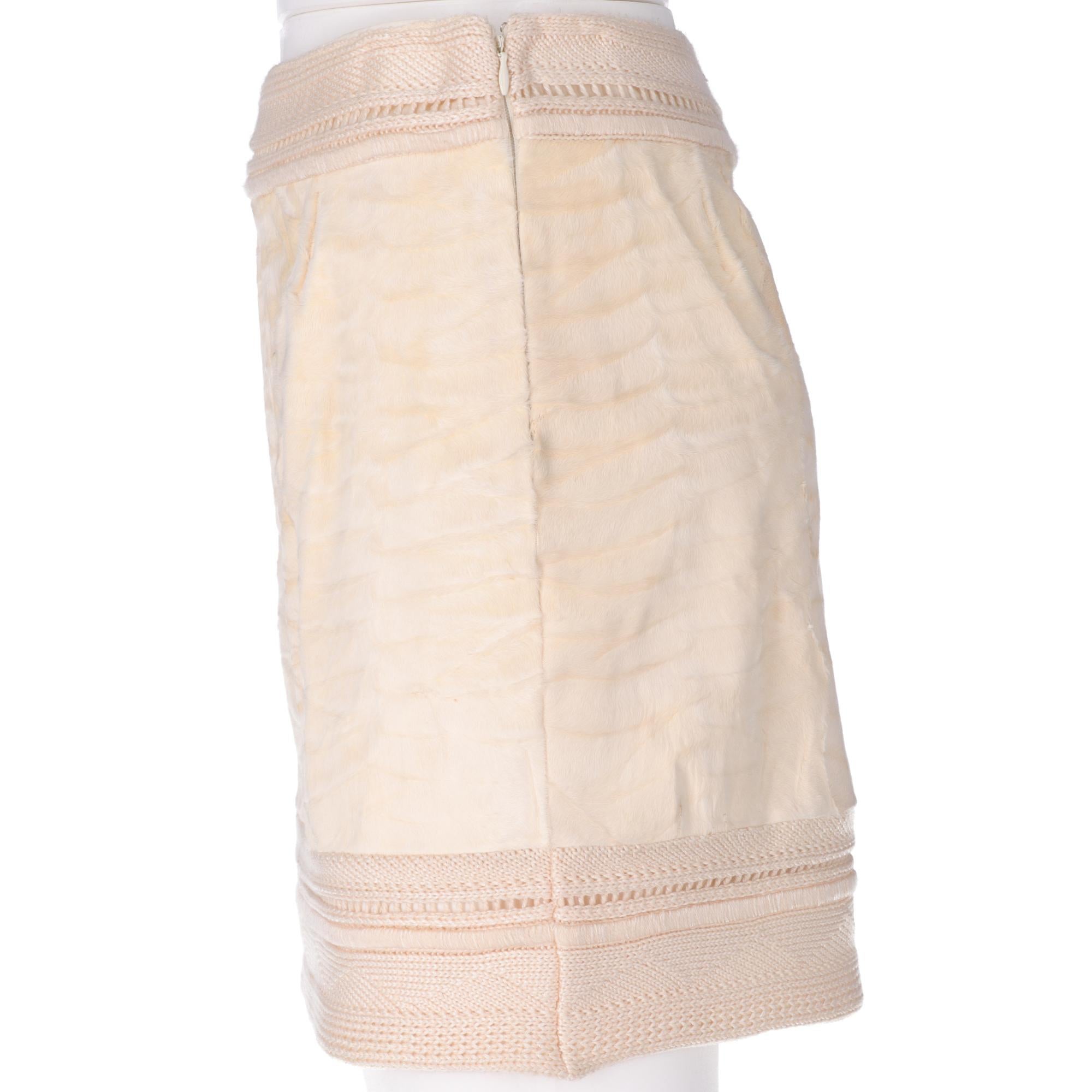 Gianfranco Ferrè high-waisted mini ivory skirt, in astrakhan fur with knitted waist and bottom band, side closure with invisible zip and hook. Lined interior. 

This item belongs to an original vintage stock: it has never been worn and comes with