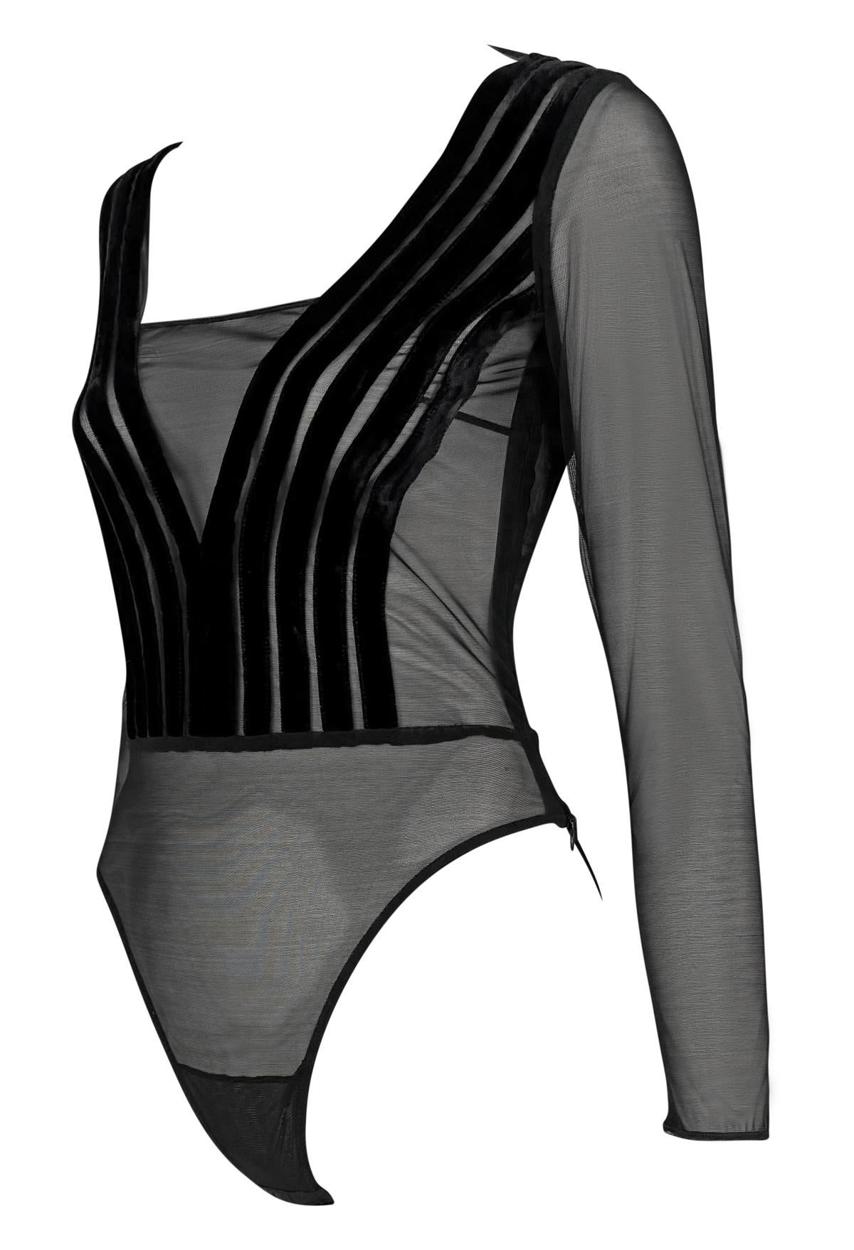 This 1990s Gianfranco Ferré bodysuit features sheer black mesh with sculptural velvet appliqué detailing in a sharp chevron design. The top is finished with a plunging neckline, long sleeves, and a high-cut silhouette.

Approximate