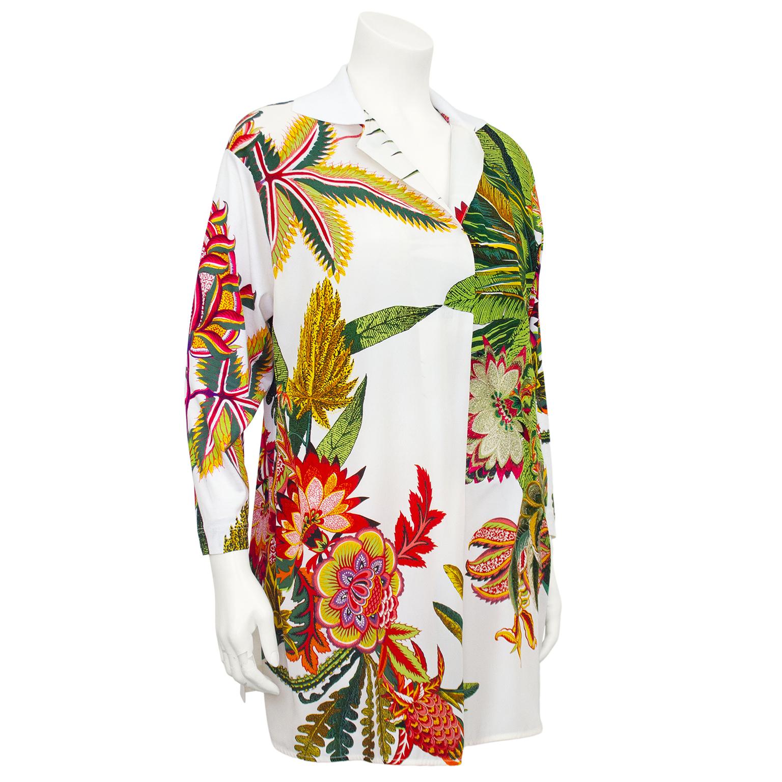 1990s Gianfranco Ferre tunic. Beautiful white silk with an all over earth tone tropical floral print. Print is embellished with meticulous embroidery. Embroidery has metallic thread throughout that picks up the light beautifully. 3/4 sleeves and