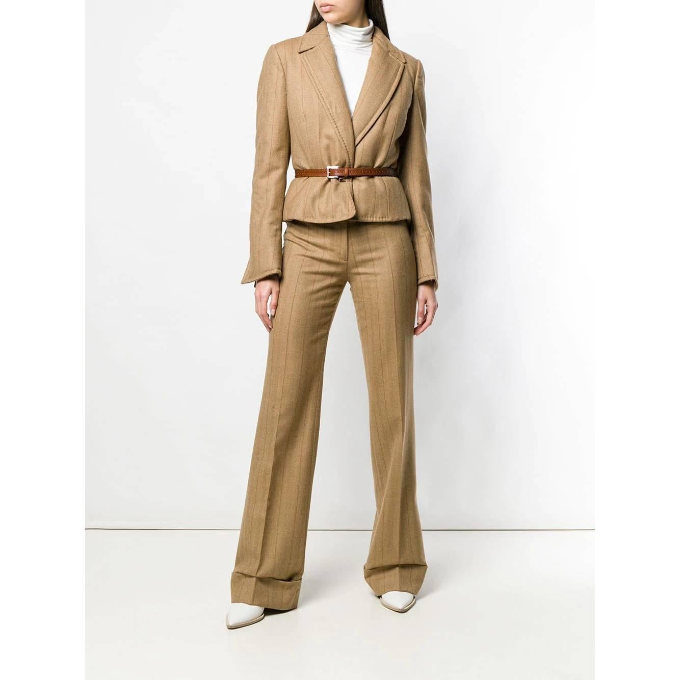 Gianfranco Ferré beige virgin wool trousers with thin vertical brown stripes. High waist, front closure with zip, button and hook. Welt pockets, front fold and turn-up at the bottom.

Years: 90s

Made in Italy

Size: 42 IT

Flat