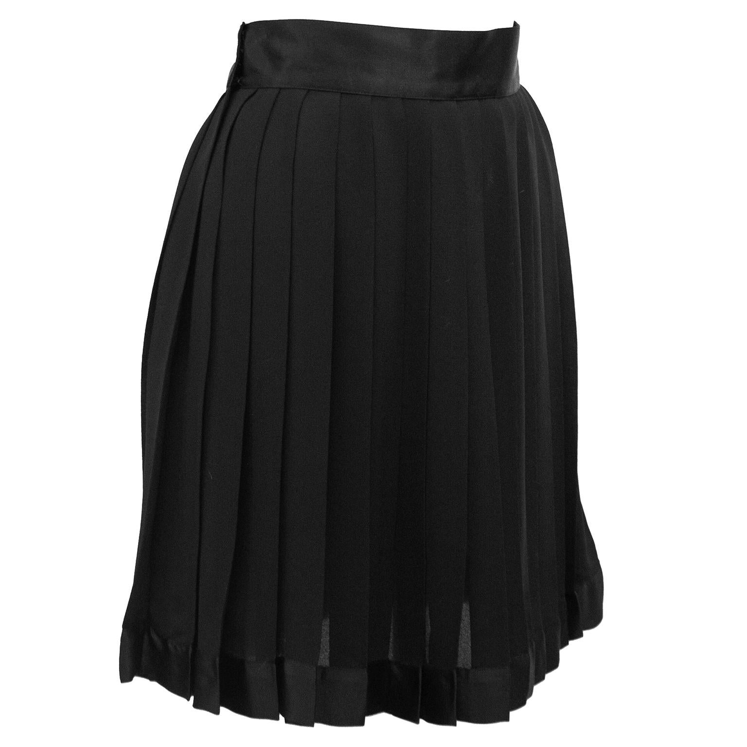 Your classic LBS (little back skirt) from the early 1990's by Gianni Versace. High waisted with a black silk satin waist band and black pleated silk chiffon skirt. Covered hook and eye closure. Black slip lining. Excellent vintage condition,