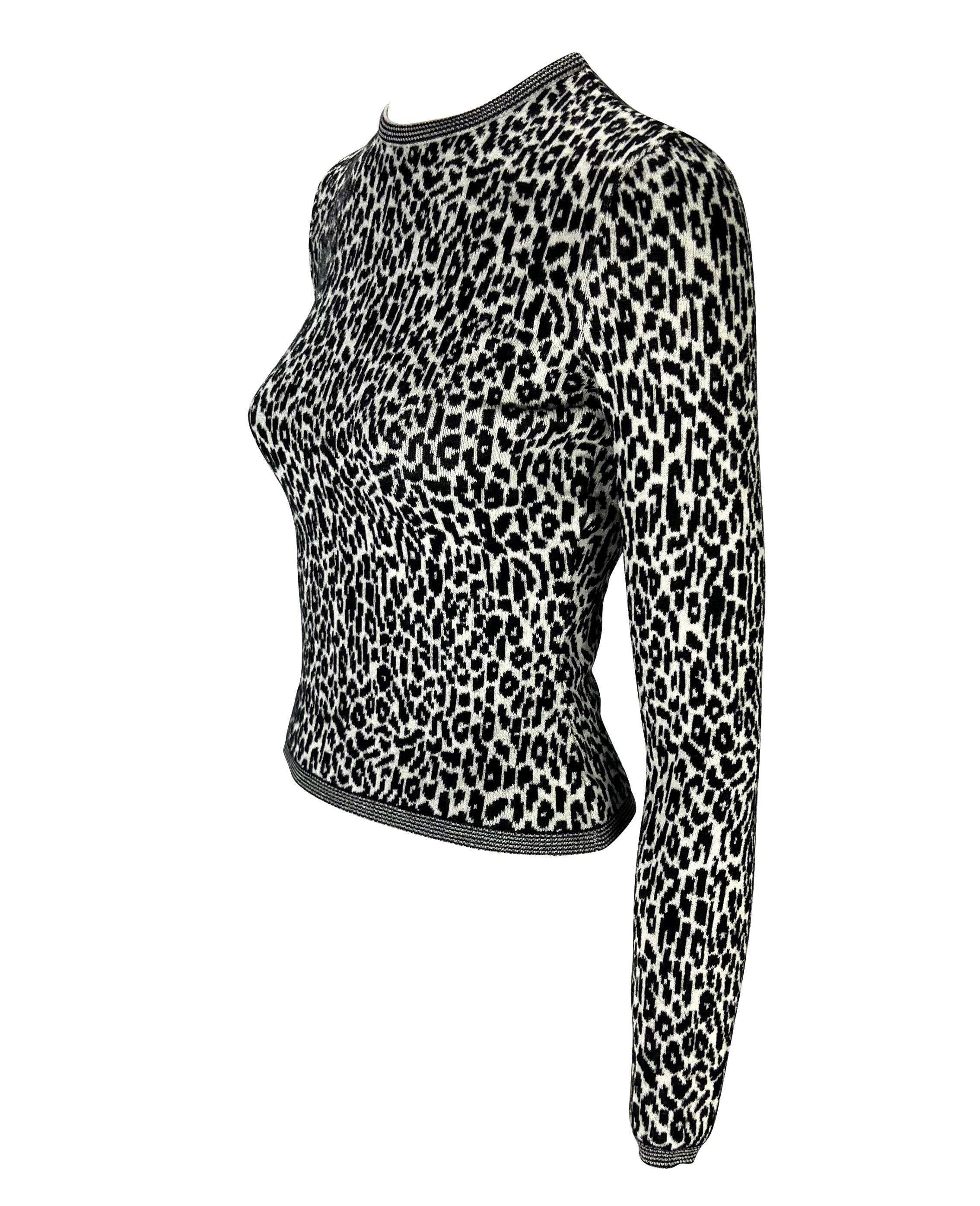 Presenting a black and white cheetah print Gianni Versace sweater, designed by Gianni Versace. From the 1990s, this beautiful sweater is covered in black and white cheetah print and is made complete with striped details around the collar, cuffs, and