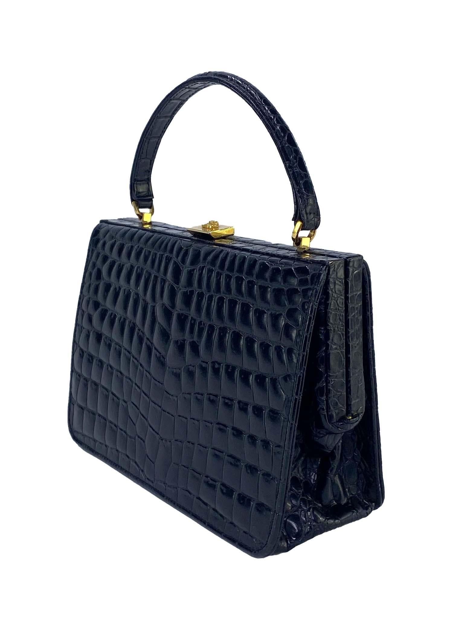 Presenting a beautiful embossed crocodile top handle Gianni Versace Couture bag, designed by Gianni Versace. From the early/mid 1990s, this bag is constructed entirely of embossed leather and features gold colored metal accents including a Medusa