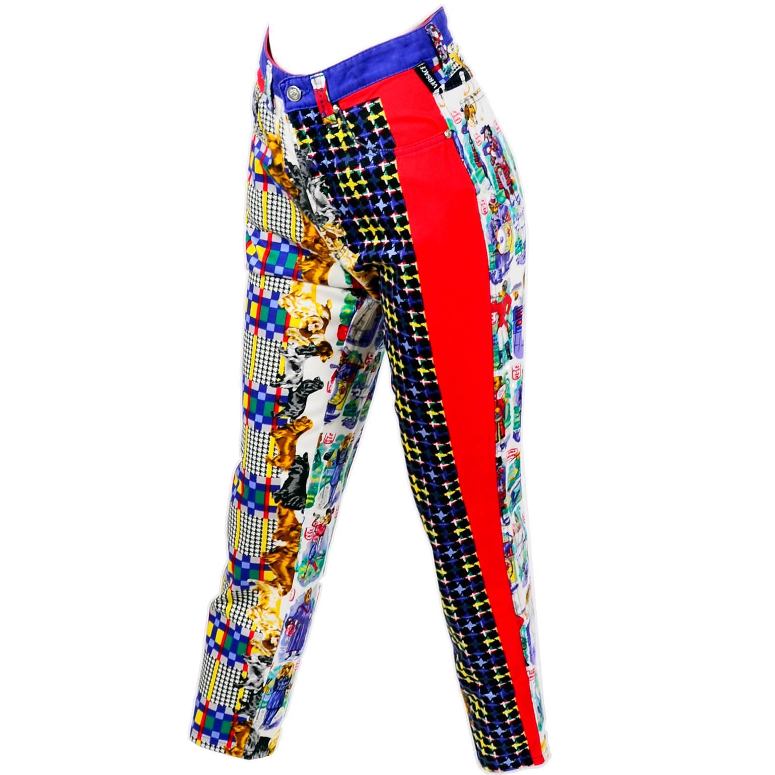 These are rare Gianni Versace Couture jeans in a novelty dog print with black and white houndstooth, bright plaids, and a red strip up the side of the left leg and a blue strip up the length of the right side.  The print includes names for dogs that