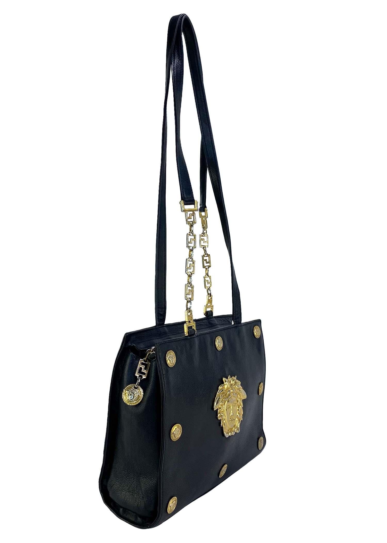 Presenting a classically Gianni Versace Couture purse, designed by Gianni Versace. Created in the early/mid 1990s, this bag constructed entirely of black leather and features a border of small Medusa logo medallions with a large gold colored Greek