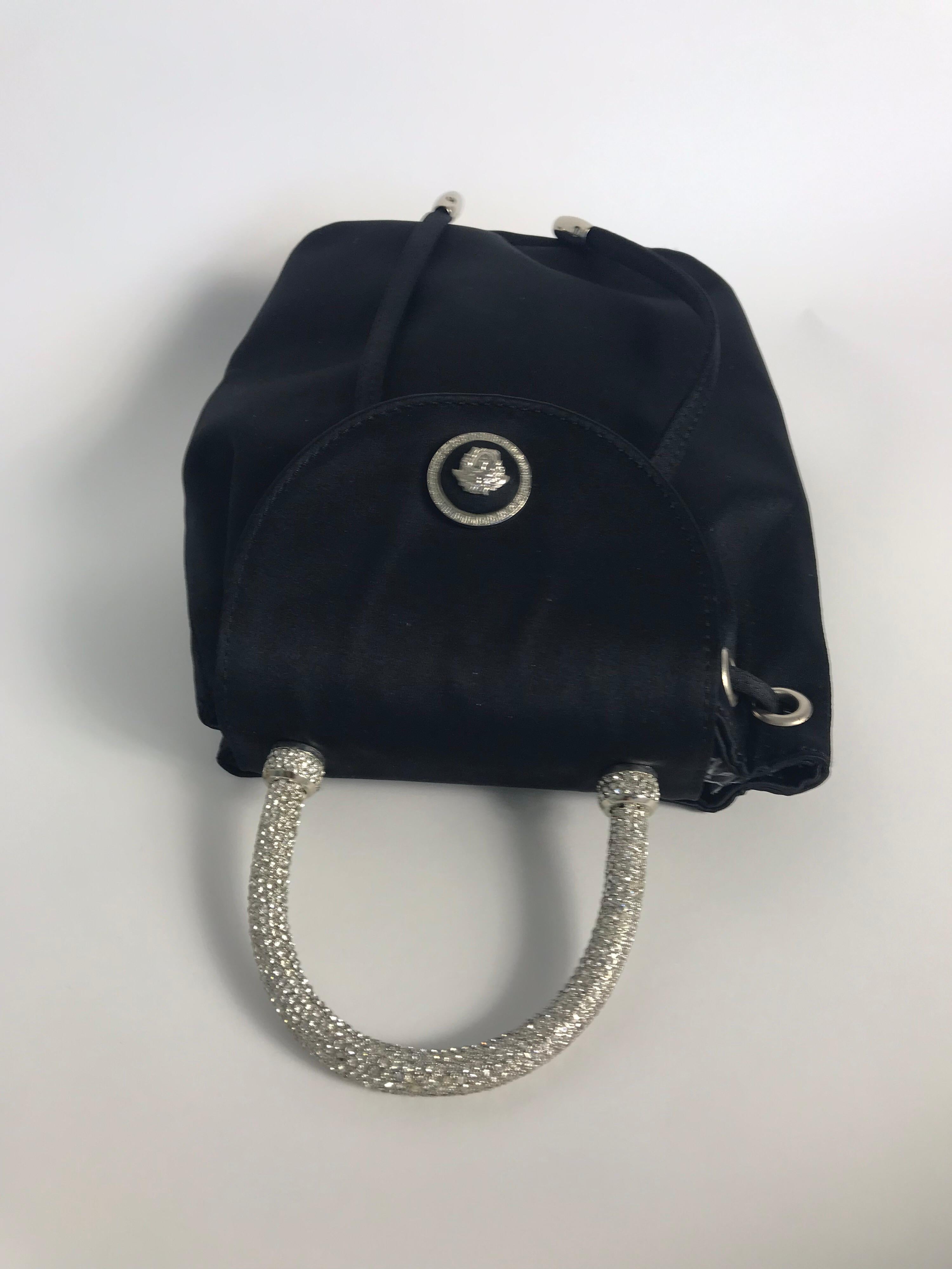 Gianni Versace Couture 1990s black nylon mini bag with drawstring, crystal encrusted handle, snap to close and Medusa. Condition: very good. 