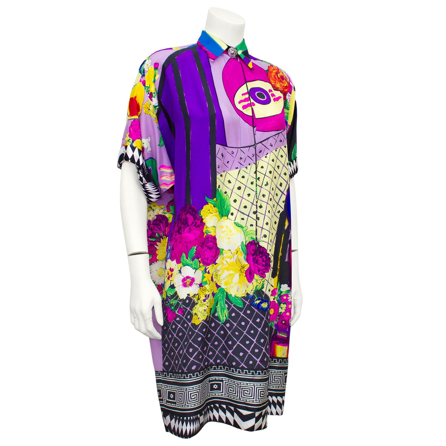 1990s Gianni Versace Couture silk shirt dress. Iconic Gianni Versace with it's mix of colours, prints and patterns. Front features a mix of purple, pink, black, white and yellow with abstract paint brush strokes and flowers. Hem features a mix of