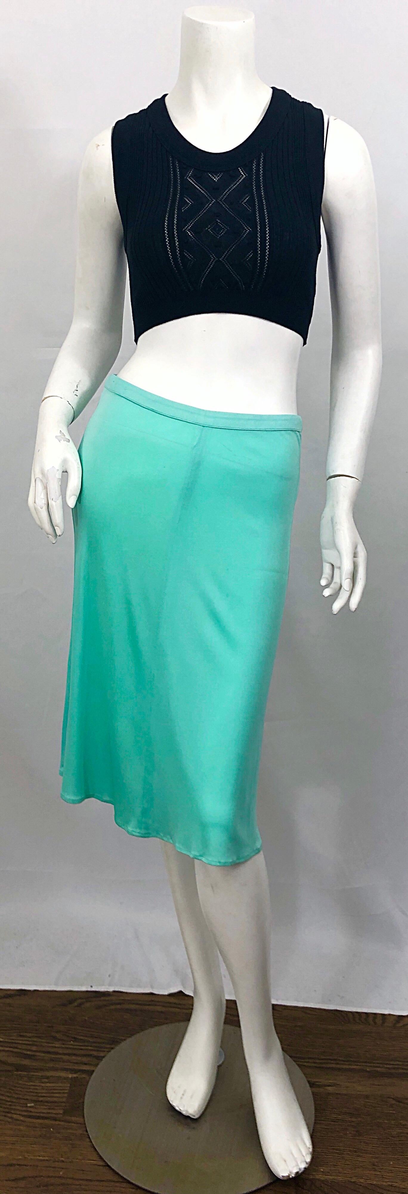 The ultimate 1990s vintage GIANNI VERSACE COUTURE turquoise / teal blue slink silk jersey skirt! The perfect vibrant blue color adds a pop of color to any outfit. Sits on the hips, with hidden zipper up the back and hook-and-eye closure. The