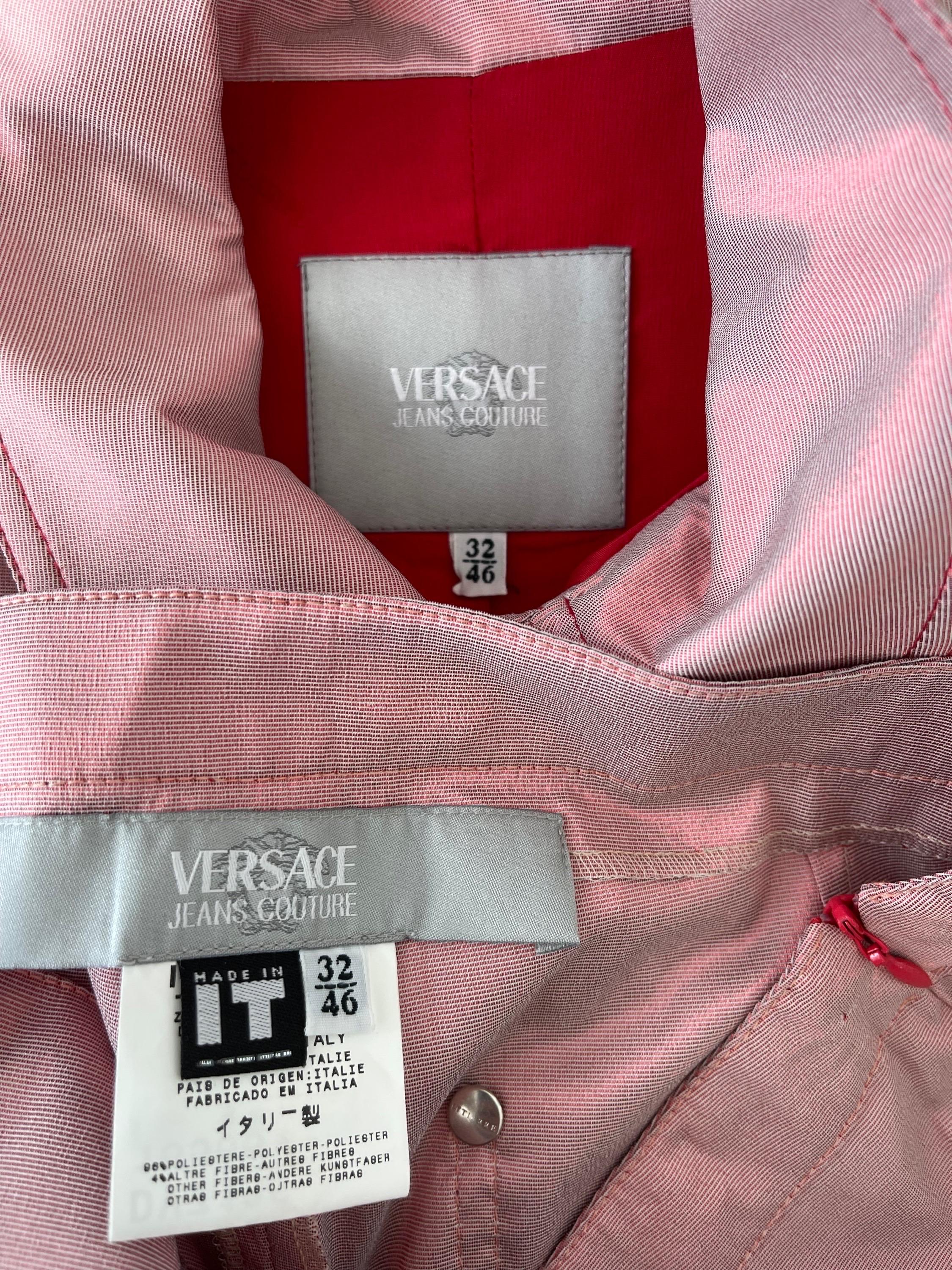 Amazing and rare 1990s GIANNI VERSACE JEANS COUTURE pink and red iridescent jacket and capri pants ensemble ! Western style jacket wit stitching at each breast pocket. Attached let features red rhinestone encrusted buckle. Silver logo encrusted