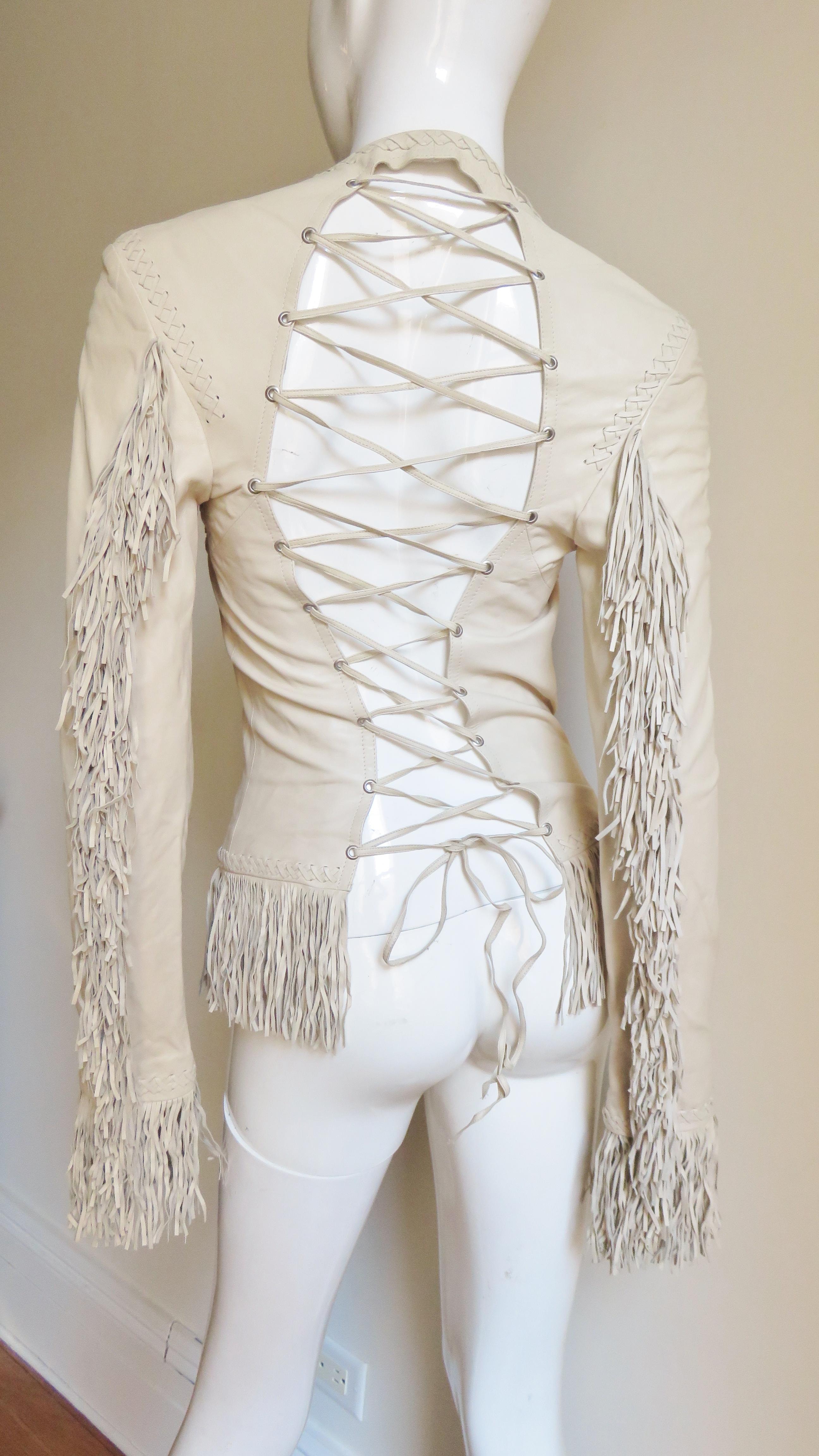 A fabulous soft, supple, fine, off white leather fringe jacket from Gianni Versace. It is fitted with vertical seaming which is highlighted with intricate hand braiding plus 4