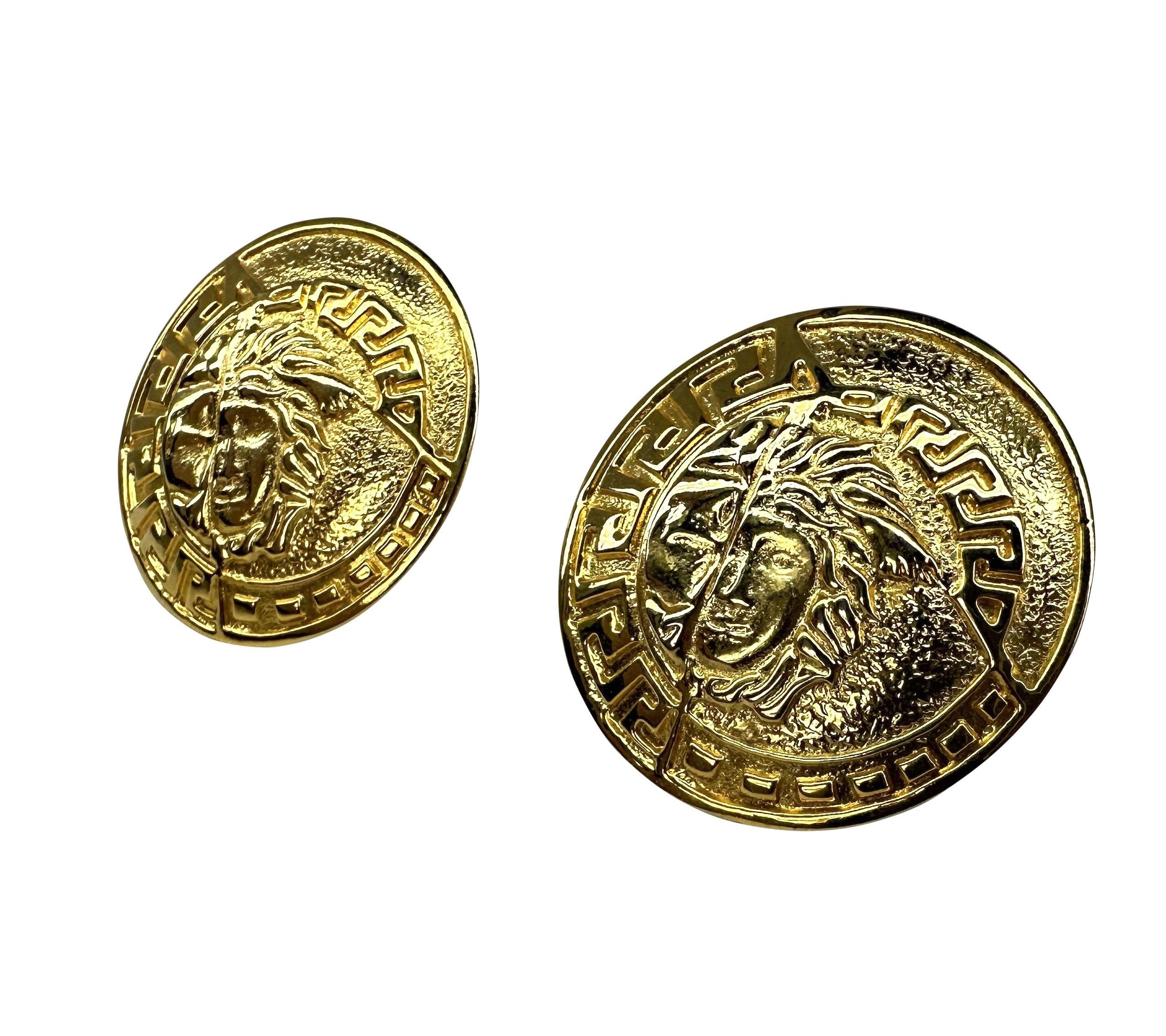 Presenting a pair of large gold-tone Gianni Versace Medusa clip-on earrings, designed by Gianni Versace. From the 1990s, these fabulous large circular earrings feature a Greek key border and are made complete with a large Versace Medusa