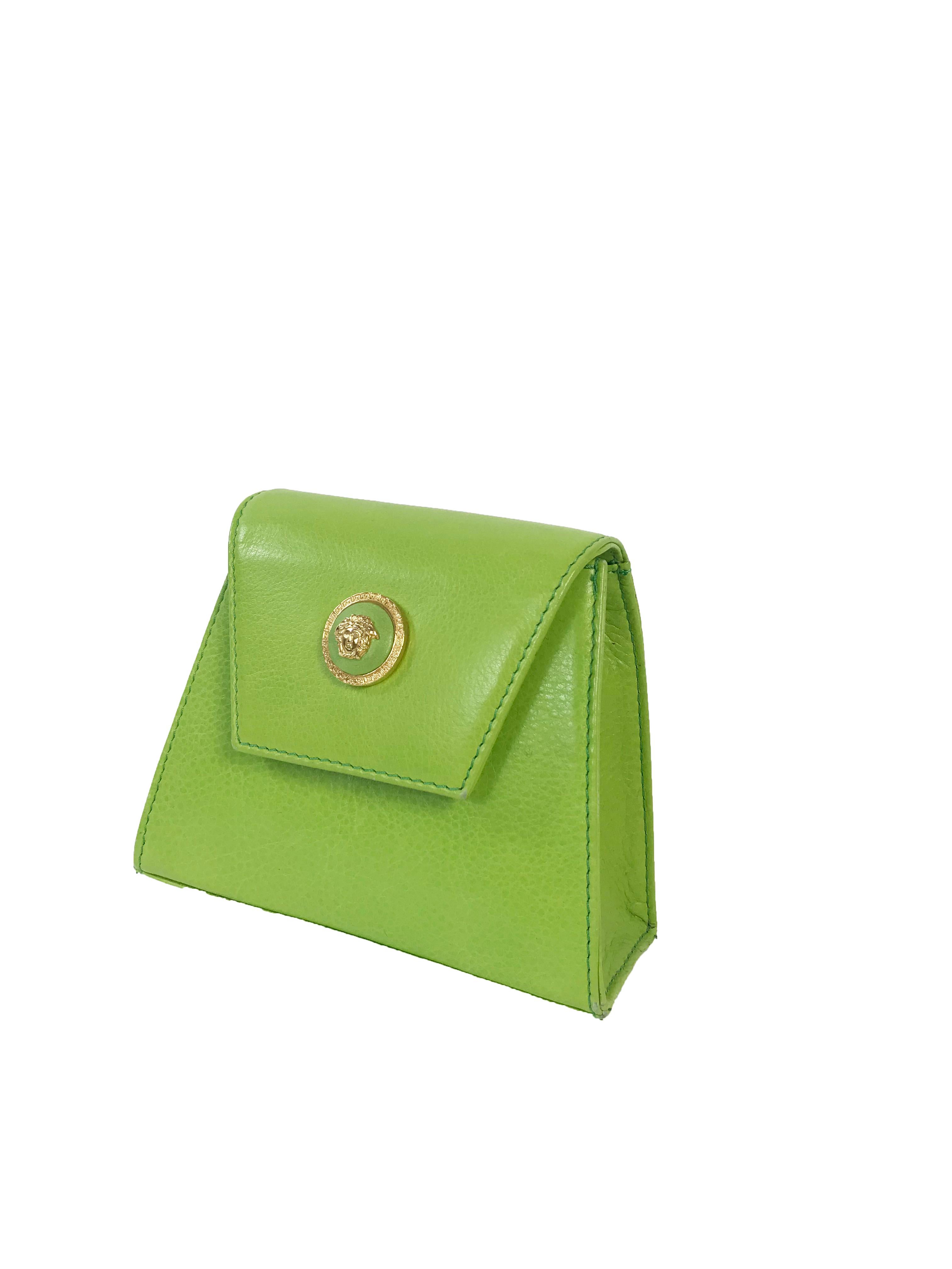 1990s Gianni Versace mini lime green leather wristlet with medusa accents. Condition: Excellent. 

