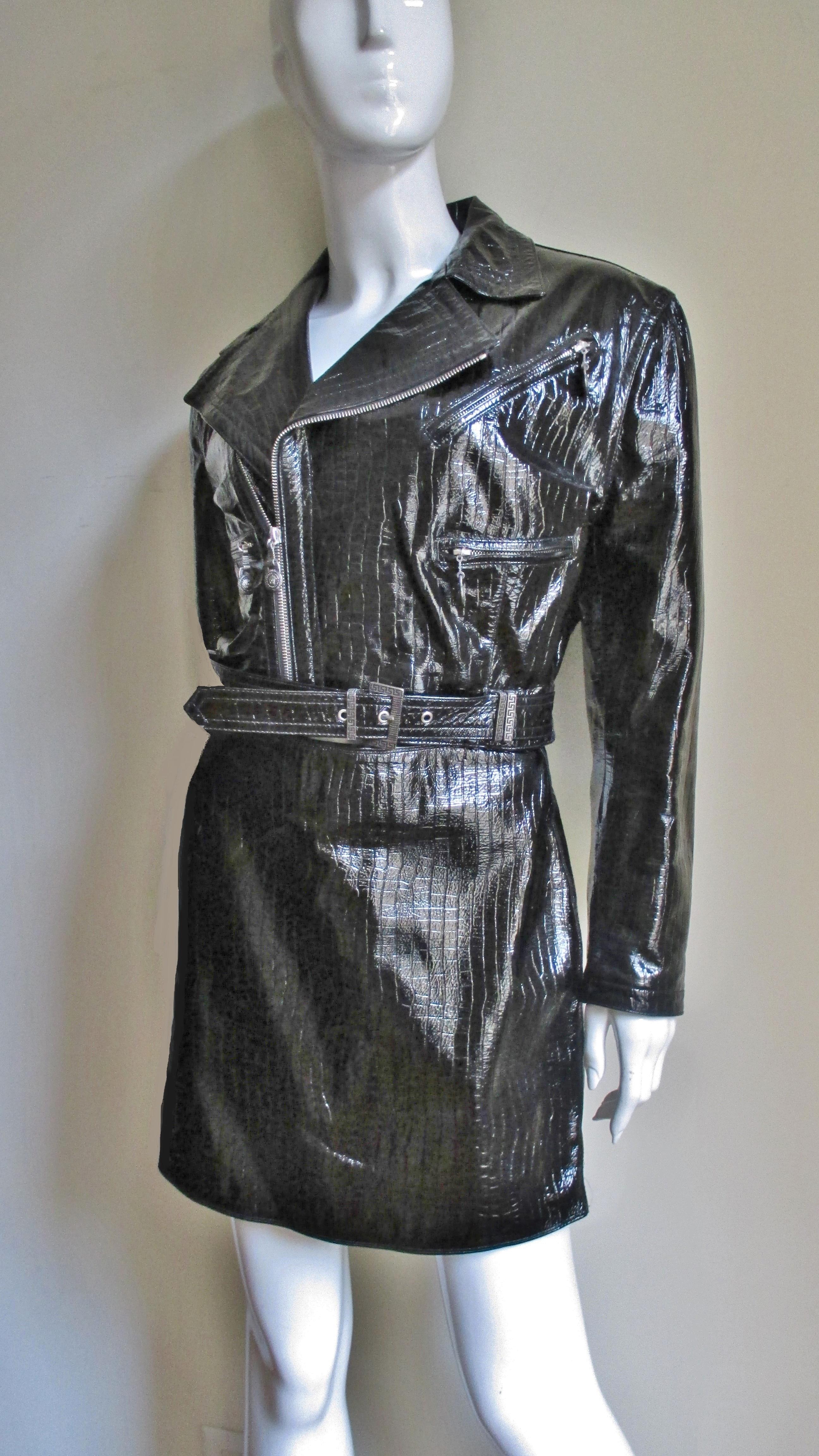 A great black patent leather motorcycle jacket with matching  skirt from Gianni Versace. Present is Versace's impeccable attention to detail including Medusa's head pulls on center front zip (which can also be used to zip jacket closed to the neck),