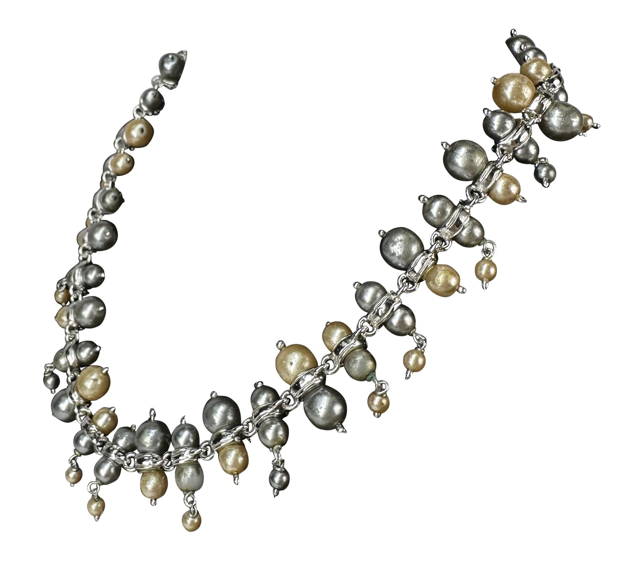 Presenting a Gianni Versace pearl costume necklace. From the 1990s, this necklace is constructed of costume pearls and features rhinestone band accents. Check out our storefront for the matching earrings!

Approximate Measurements:
Length: