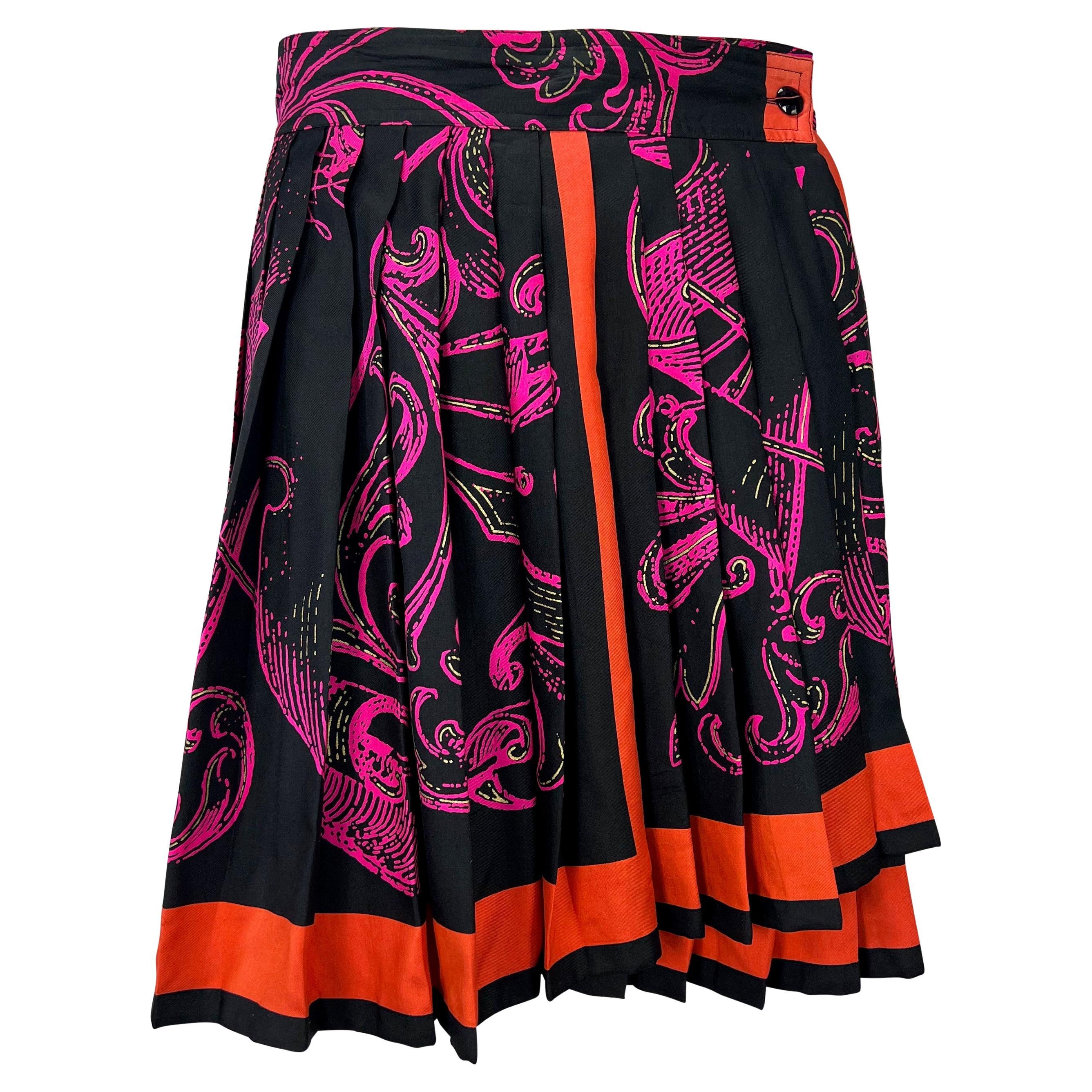 Presenting a bold pink and black baroque print wrap skirt with orange trim designed by Gianni Versace in the early 1990s. The accordion pleating and wrap construction give this light skirt bounce with every step. Check out our storefront for more