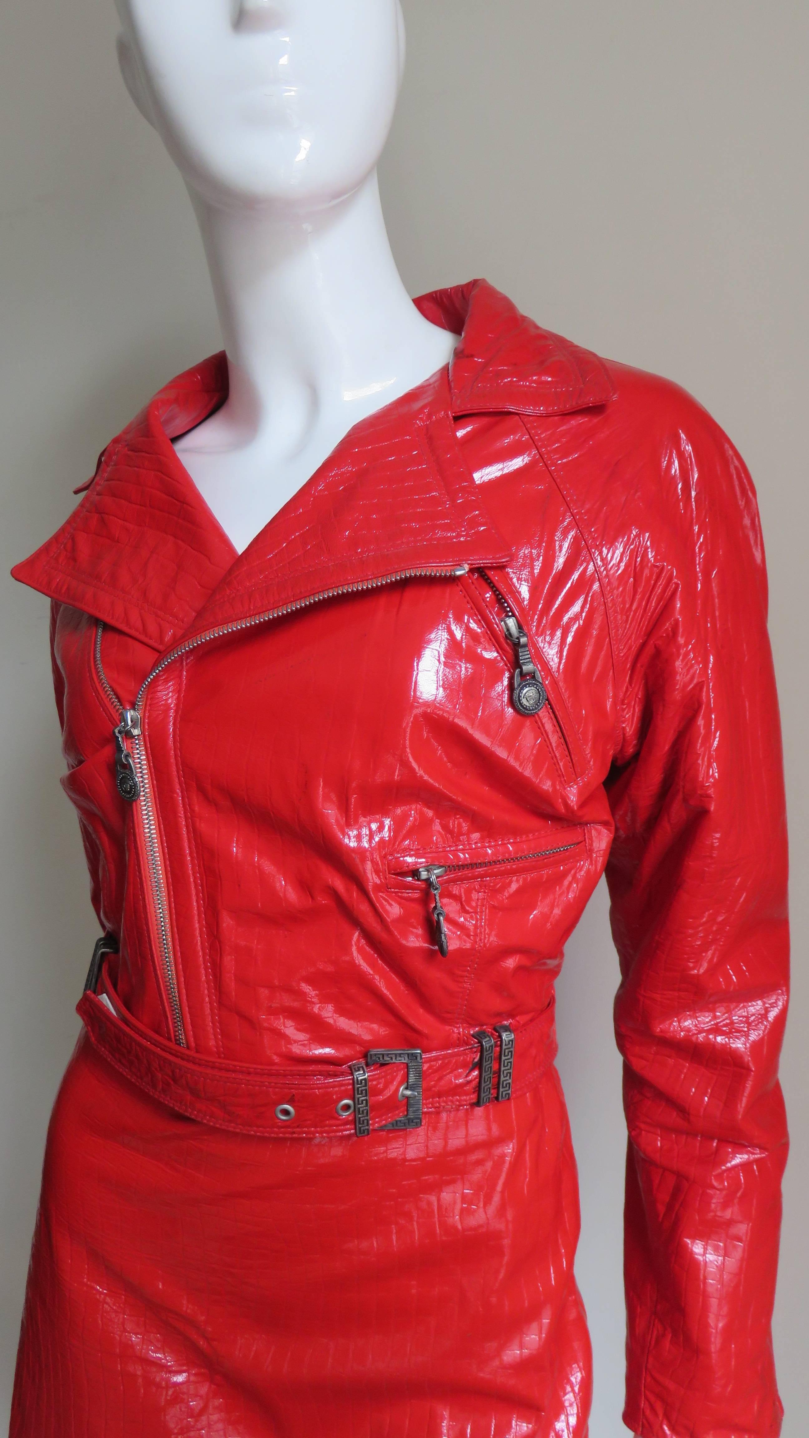 A fabulous and rare red patent leather motorcycle jacket with matching skirt from Gianni Versace. It has all of Versace's amazing attention to detail including Medusa head pulls on the center front zip, wrist zippers and 4 jacket front zipper