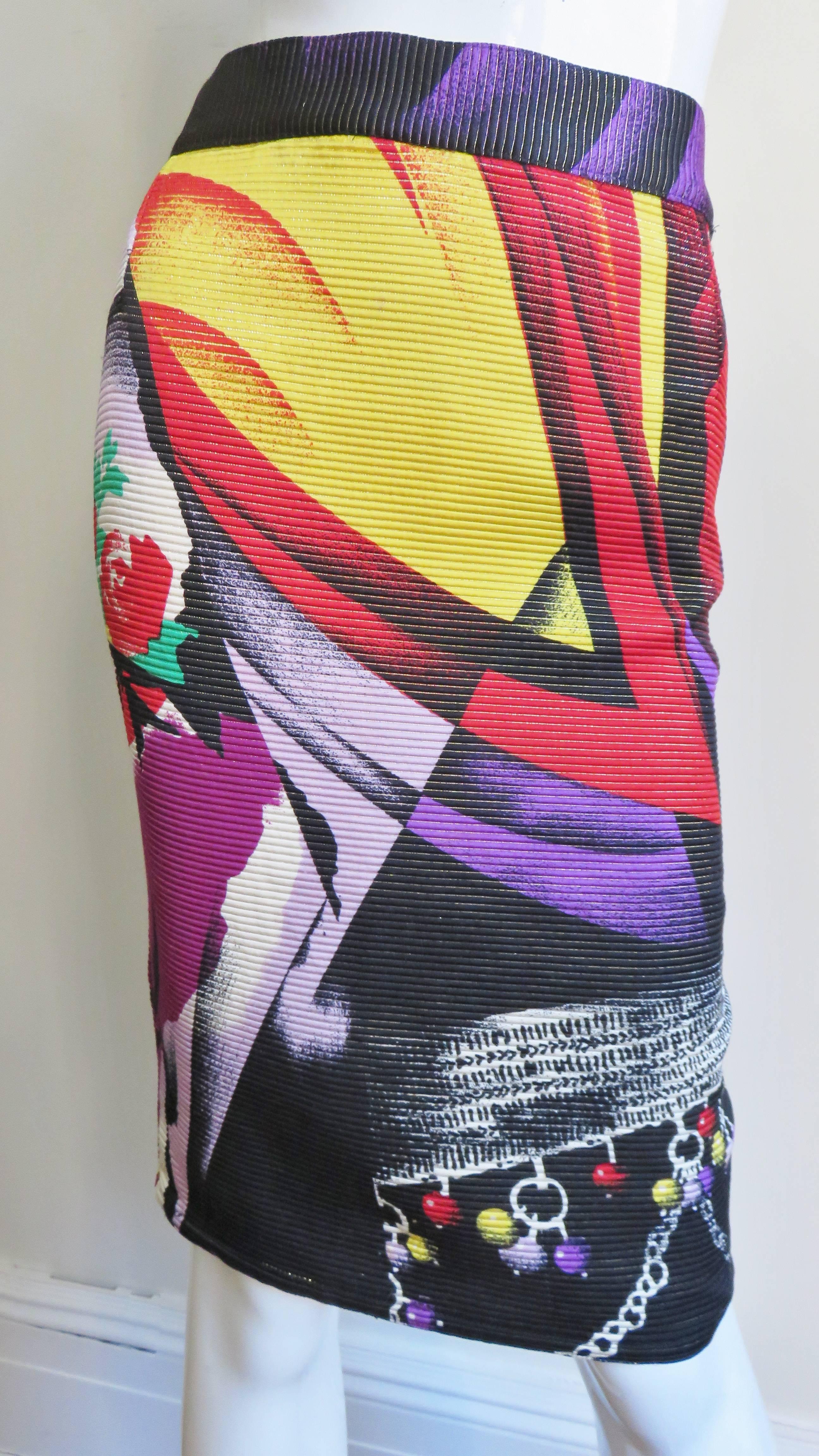 A gorgeous colorful silk skirt by Gianni Versace in a pattern of abstract shapes and flowers. It is pencil style with a waistband and button closing, side zipper and silk lining.  
Fits size Medium.

Waist  32