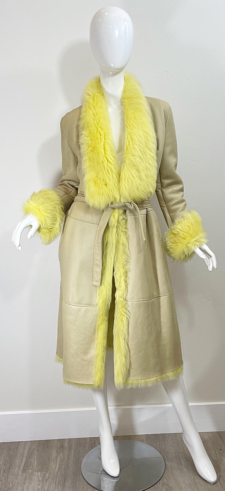 Chic and collectible 1990s GIANNI VERSACE tan leather and bright yellow shearling fur trench jacket ! Features the finest buttery soft leather. FULLY LINED in warm yellow shearling. Matching detachable belt. Pockets at each side of the hips. 1990s
