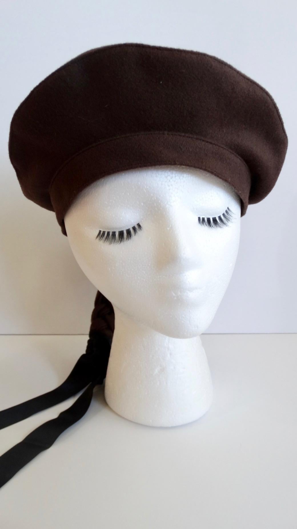 Elevate Your Hat Game With This Amazing Beret! Circa 1990s, this Gilles Francois French felt beret is a rich chocolate brown color and features a braided ponytail accent complete with a black ribbon tied at the end. On the side is a small millefiori