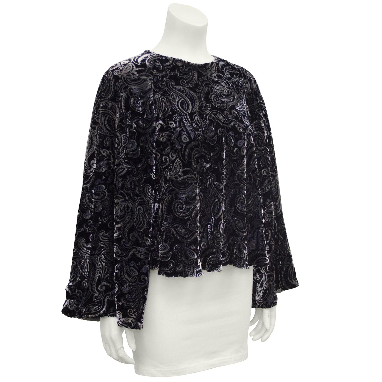 Beautiful and bohemian 1990s Giorgio Armani blouse. Black, grey and blue velvet paisley all over. Loose trumpet shaped sleeves and a-line bodice create beautiful draping. Tiny pearl and rhinestone buttons down centre back elevates this piece to