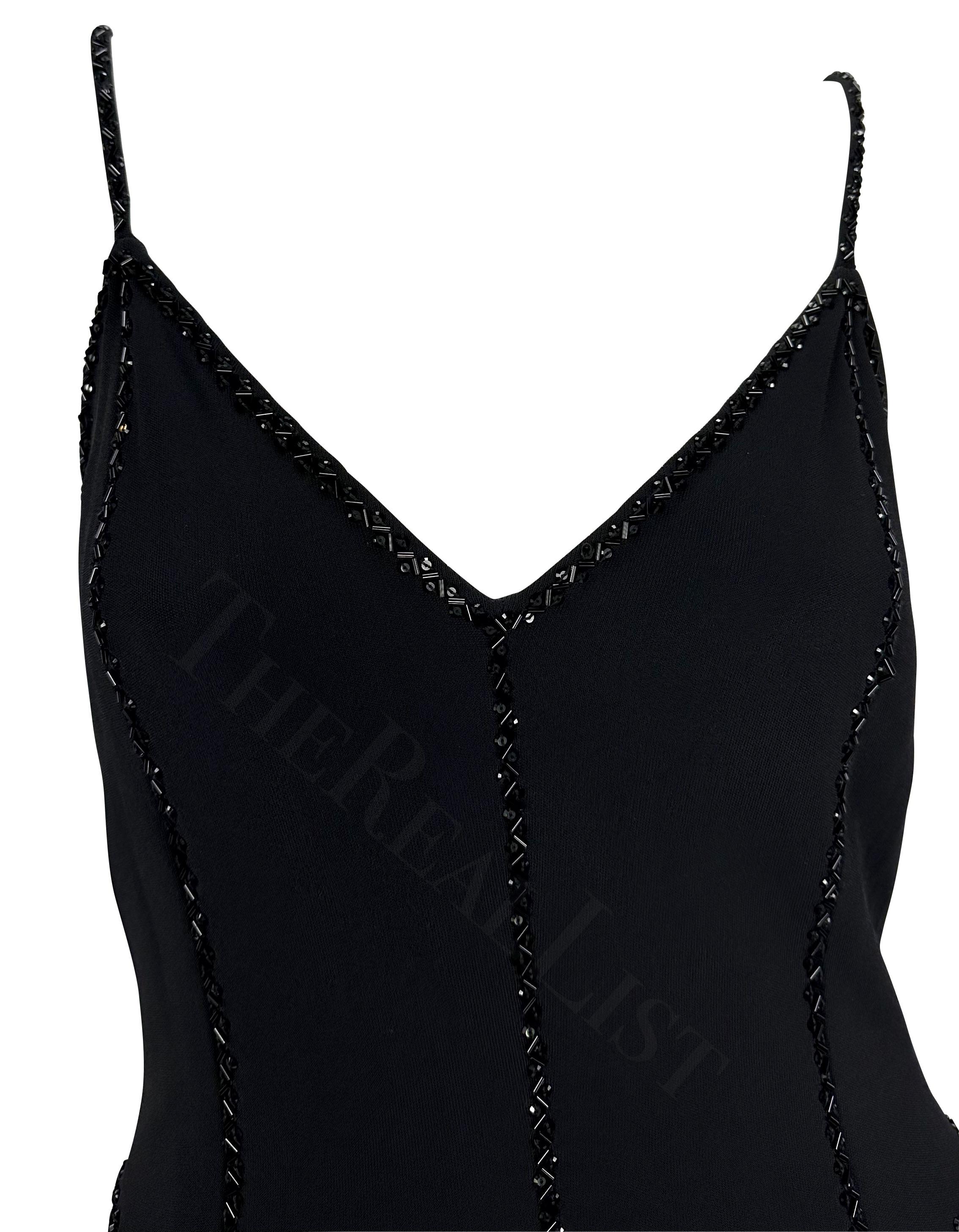 Presenting a fabulous black Giorgio Armani dress. From the 1990s this dress features a semi-exposed back, v-neckline, and spaghetti straps, and is made complete with black beaded details throughout. 

Approximate measurements:
Size - IT42/US8
Bust: