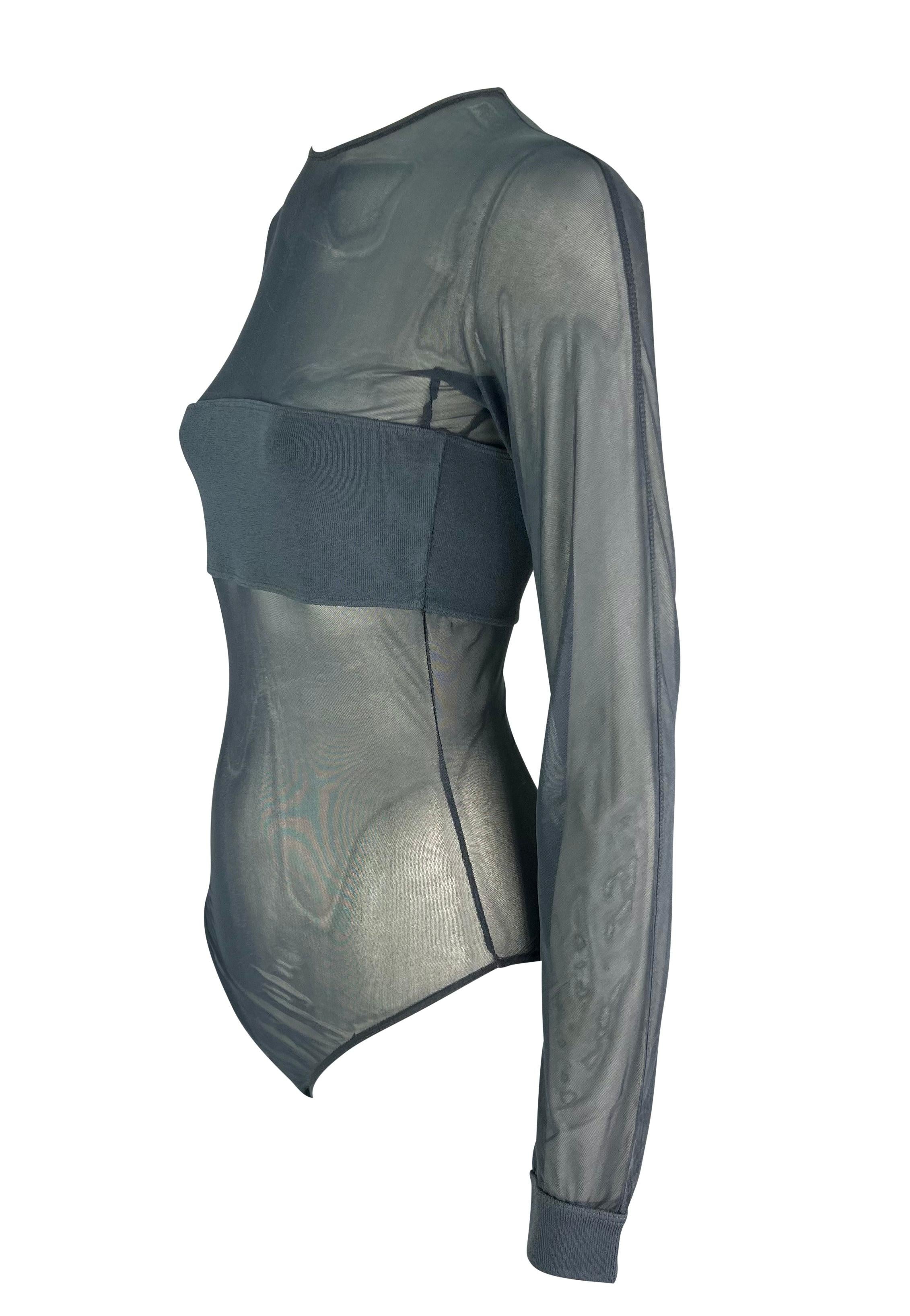 This dark grey sheer long sleeve bodysuit from the 1990s by Giorgio Armani features a sleek, minimalist design. The bodysuit is crafted from a semi-transparent mesh fabric, offering a fitted silhouette with ribbed cuffs and a bandeau-style band