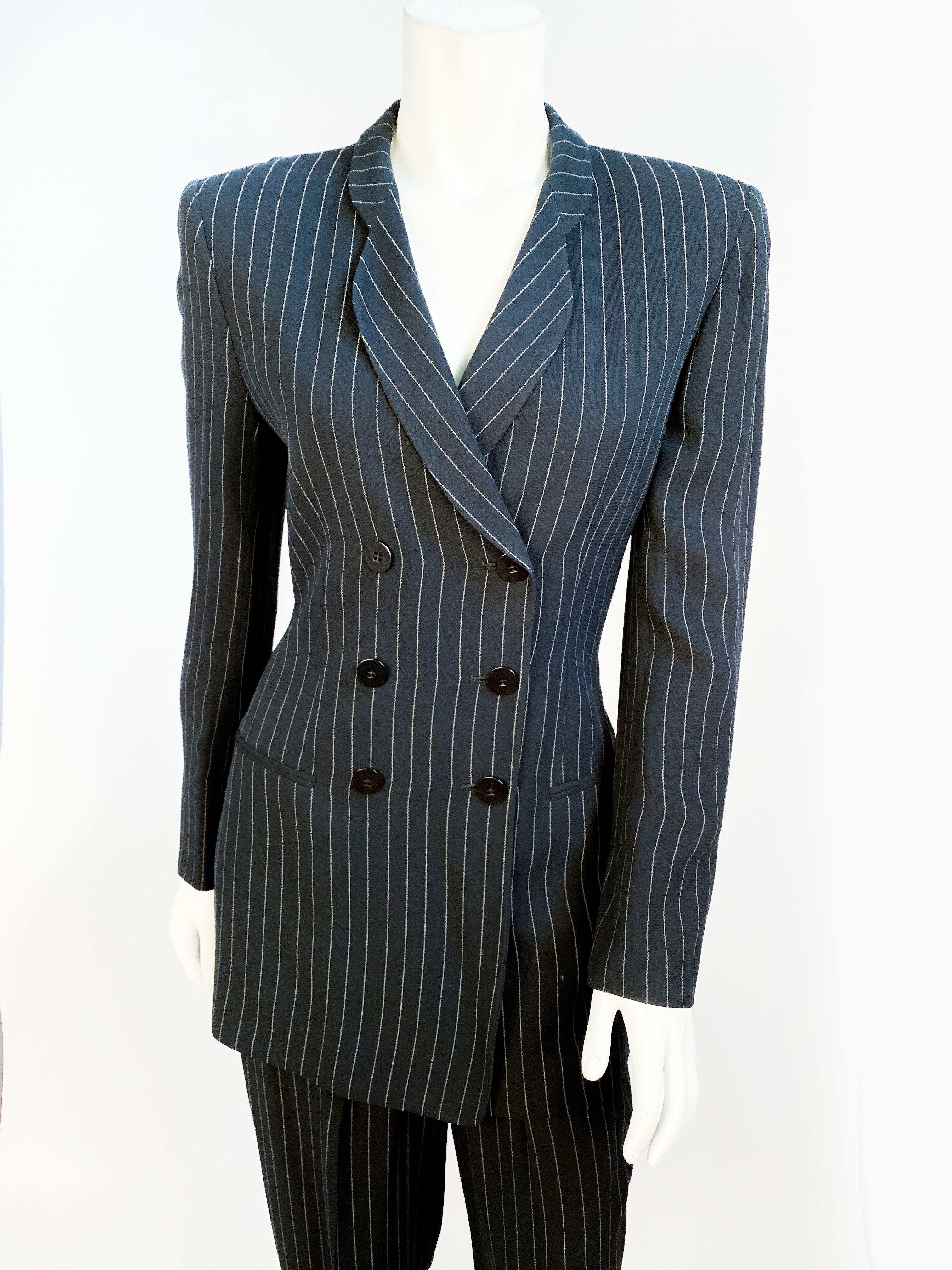 1990s Giorgio Armani Le Collezioni womens pinstripe double-brested suit in navy rayon. Matching pant are high-waisted and fitted. 