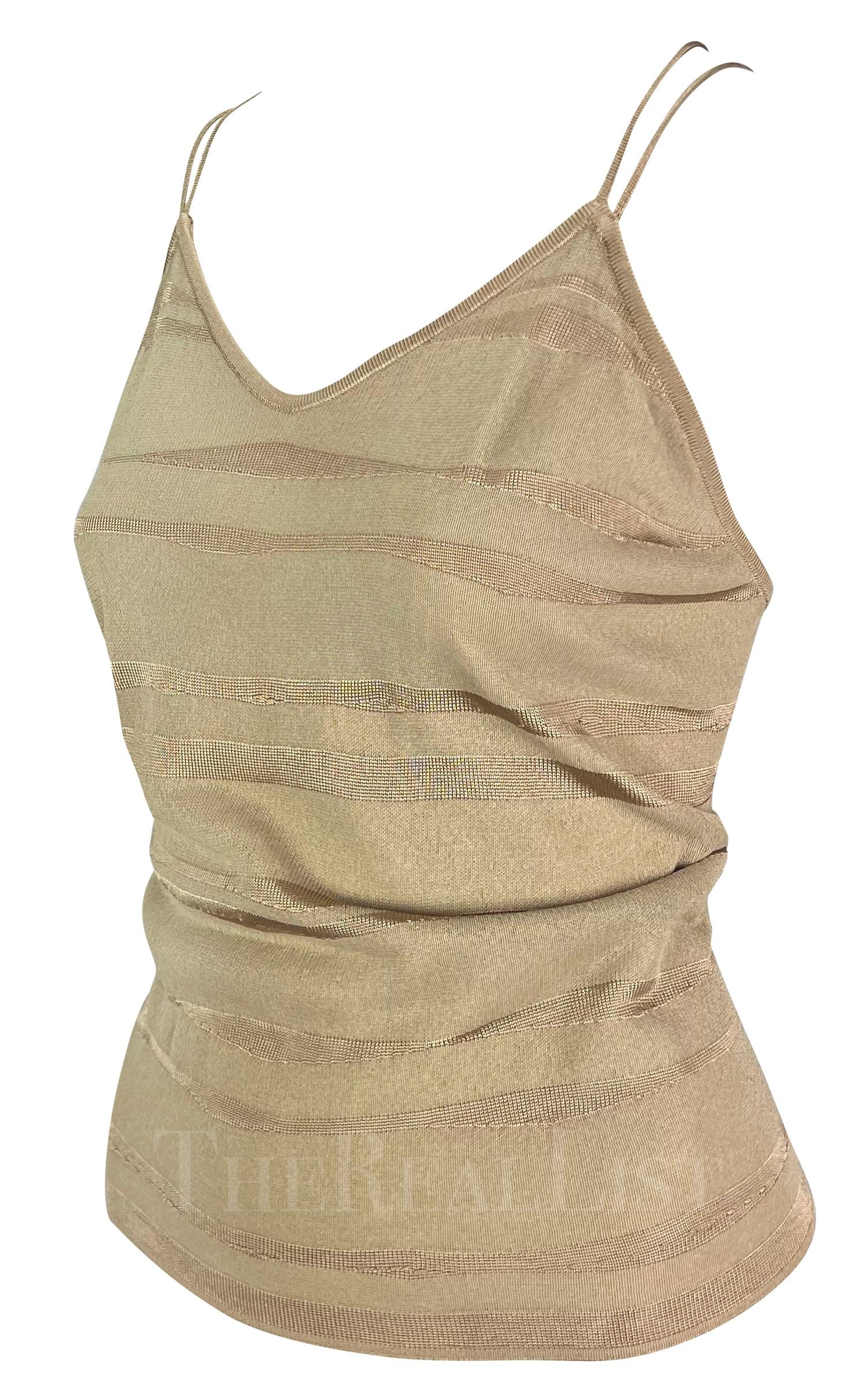 TheRealList presents: a chic beige Giorgio Armani knit tank top. From the 1990s, this top features a knit undulating stripe pattern throughout and is made complete with spaghetti shoulder straps that cross the semi-exposed back creating a diamond