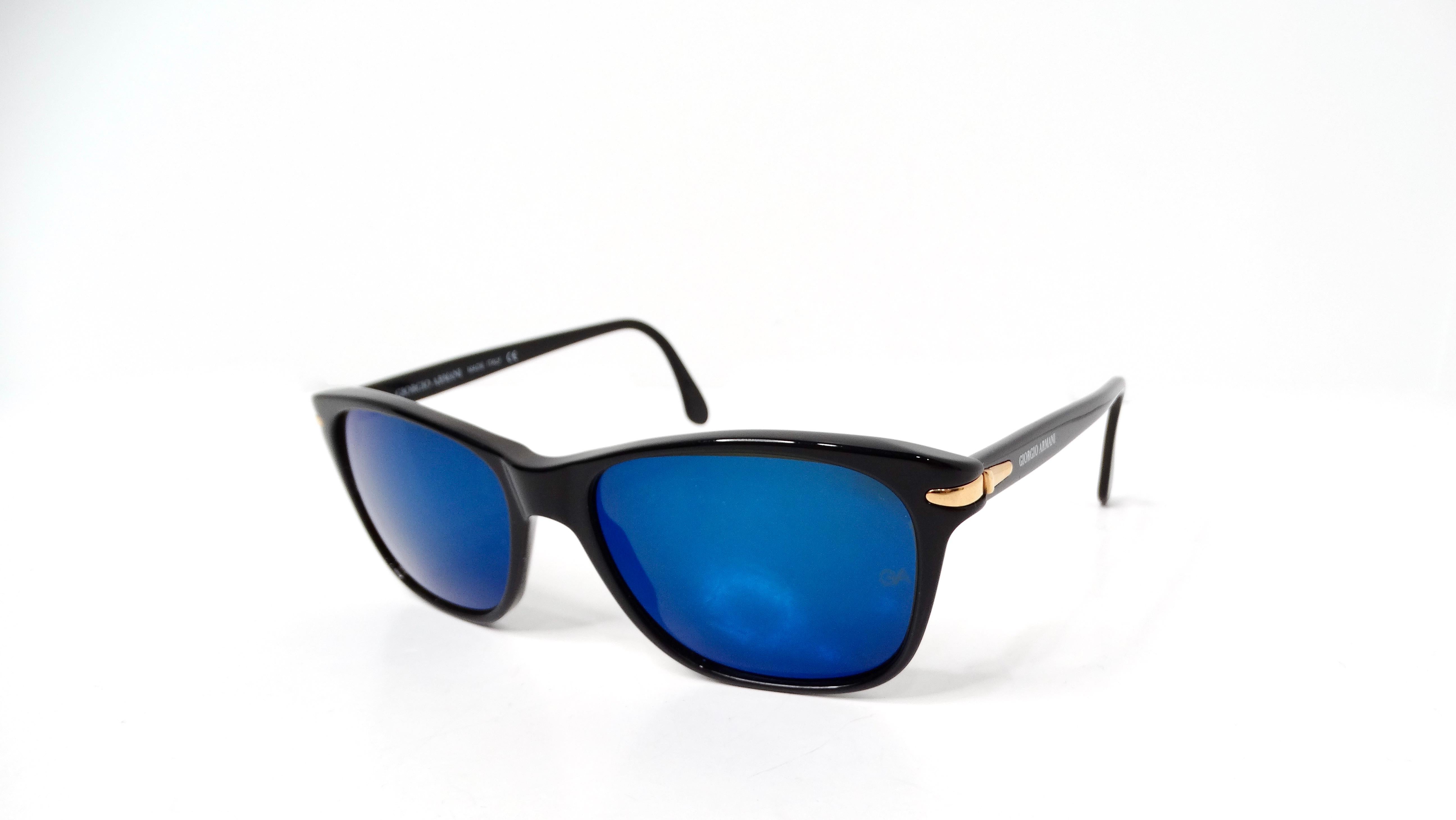The 1990s Giorgio Armani Wayfarer sunglasses are a stunning accessory that embodies the elegance and sophistication of that iconic era. Featuring a sleek black frame adorned with gold-tone details on the sides, these sunglasses exude a luxurious