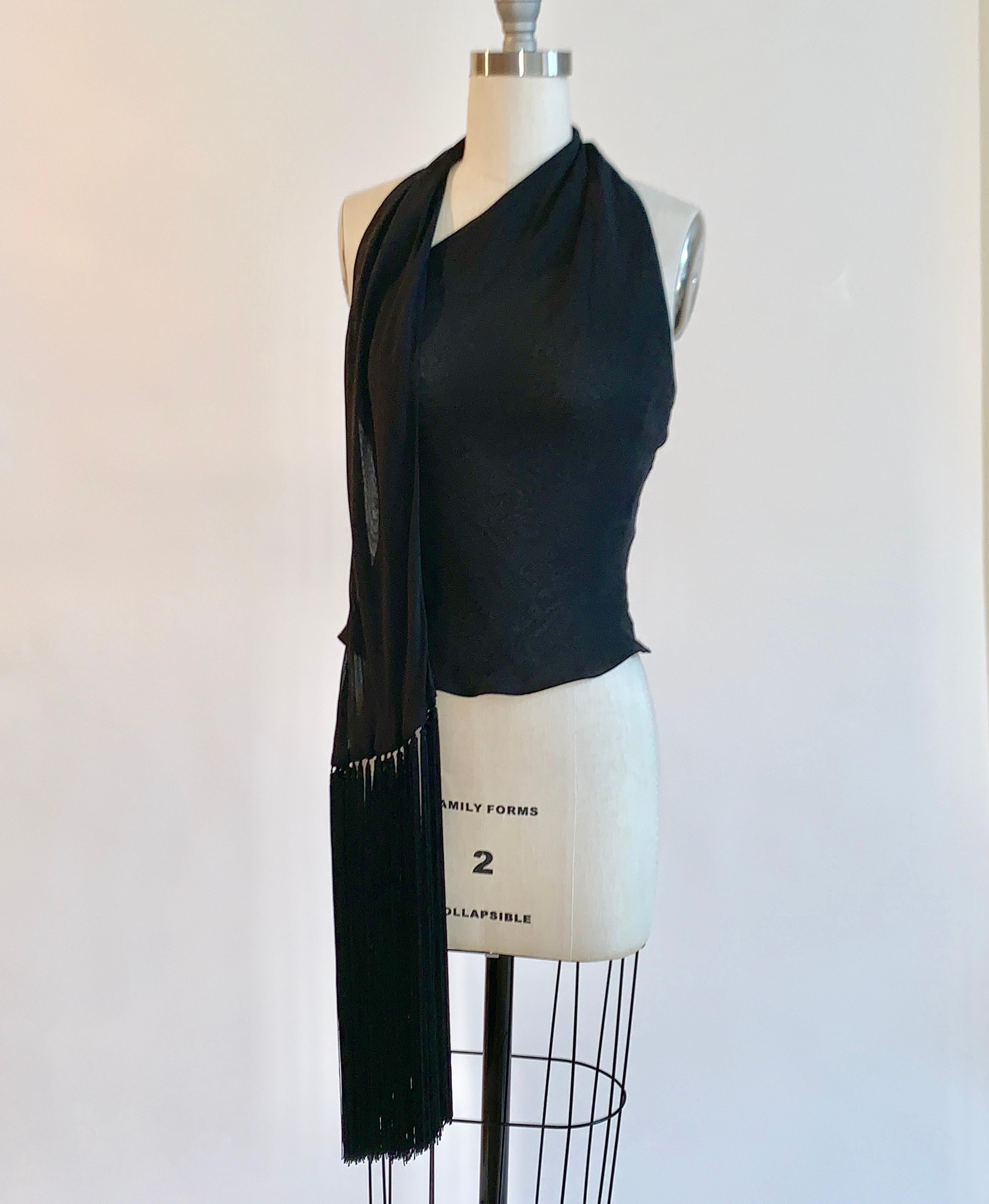 Vintage Givenchy Couture late 1990s black halter top with beautiful long fringe trim on strap that drapes over one side of shoulder and wraps around neck (or could hang straight down back, if desired.) Two layers of sheer fabric create a semi-sheer