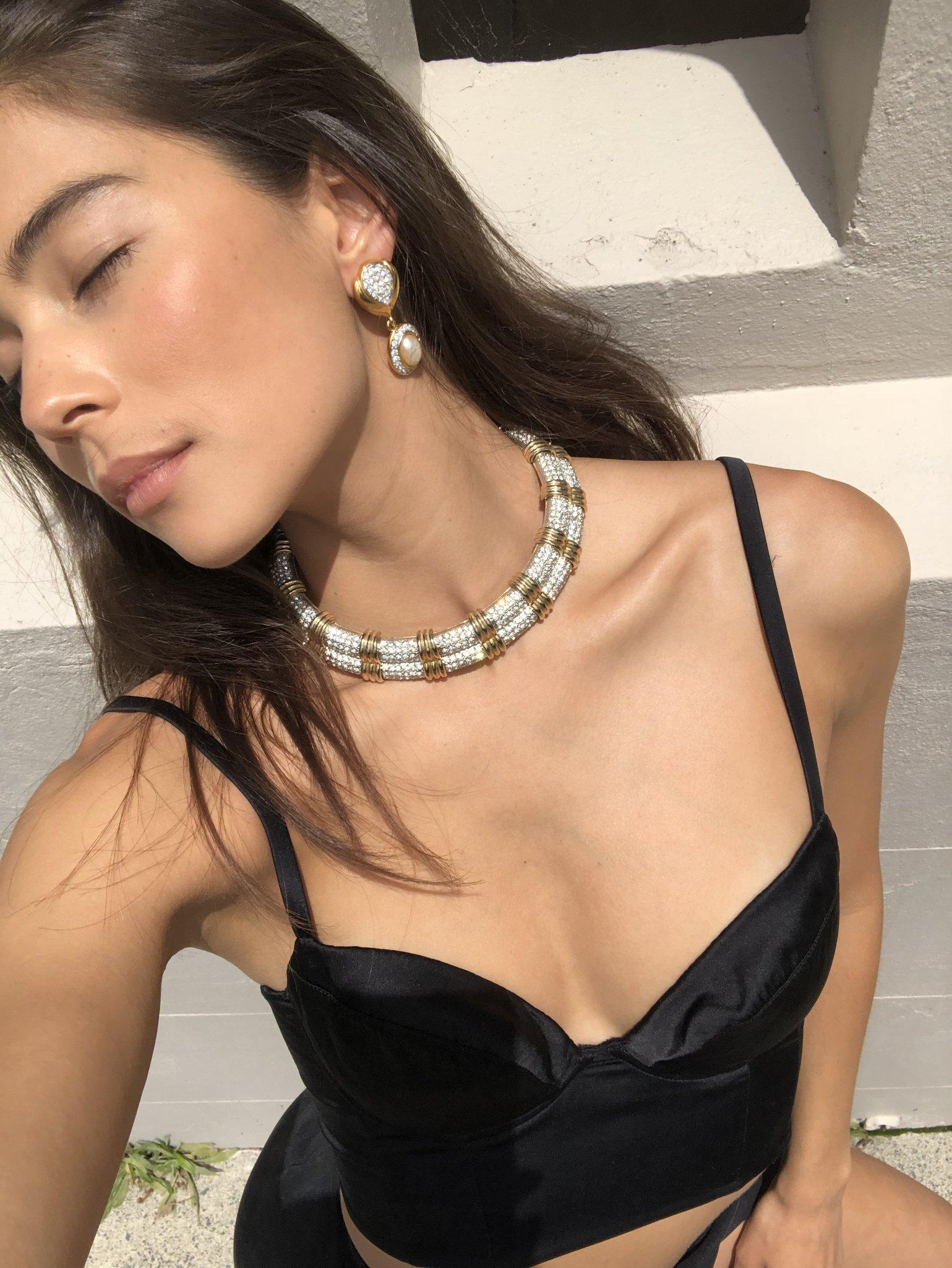 This incredible choker is the definition of a statement piece, with textured gold and silver tone, crystals and a hinged clasp. Big and bold, it's 90s vintage at its finest.  Wear with a simple LBD or a sharp tuxedo suit, sans shirt, to ring in the