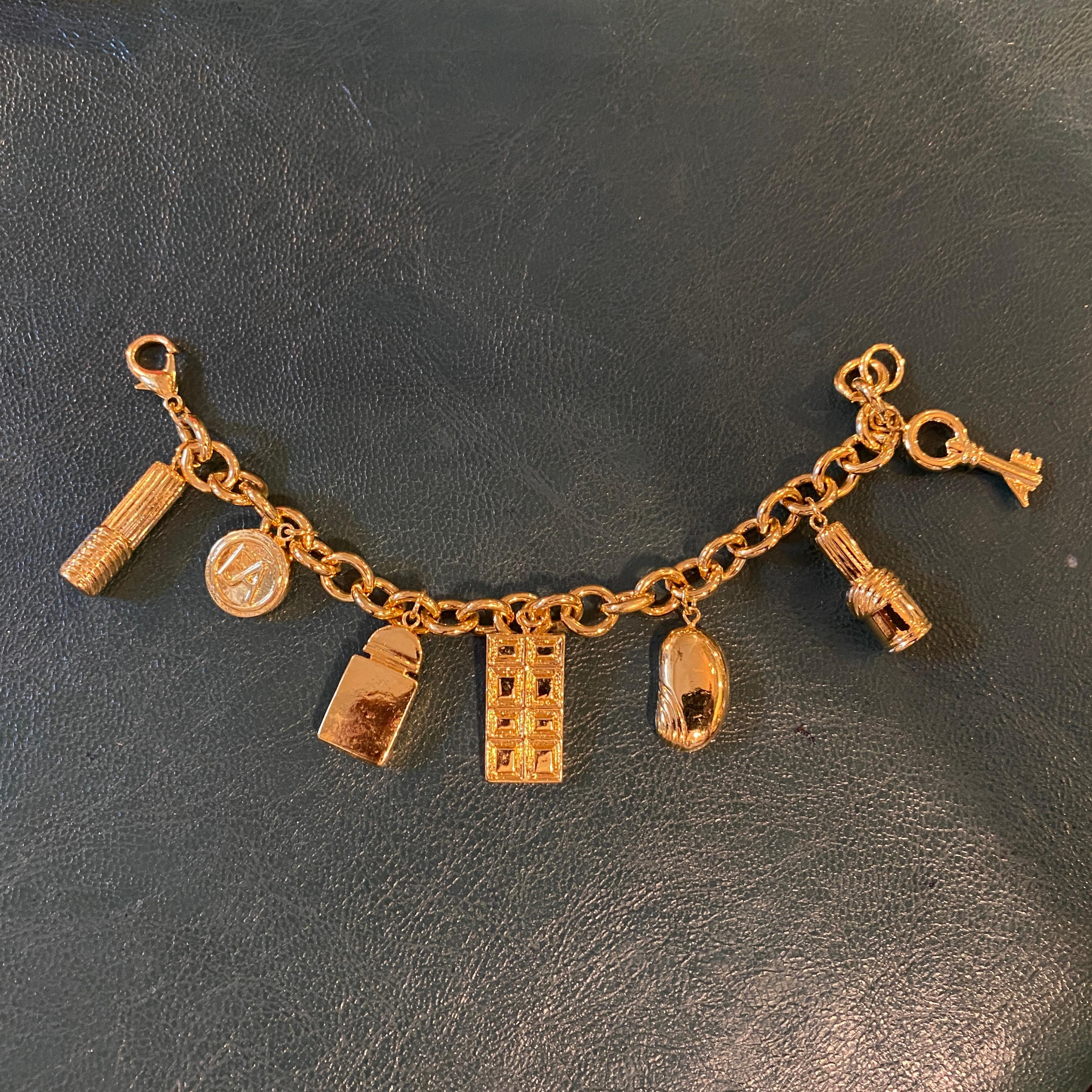 A never worn gold electroplated charm bracelet made exclusively for Elizabeth Arden, complete with box. 