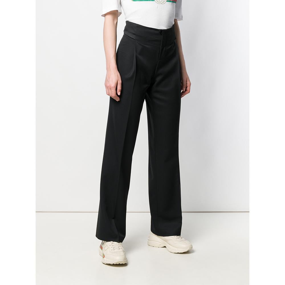 Flared Gucci trousers in black wool with high waist, front closure with button and zip, tape and logoed hook on the back.
Years: 90s

Made in Italy

Size: 38 IT

Linear measures

Waist: 35 cm
Hips: 50 cm
Inside Leg: 88 cm
