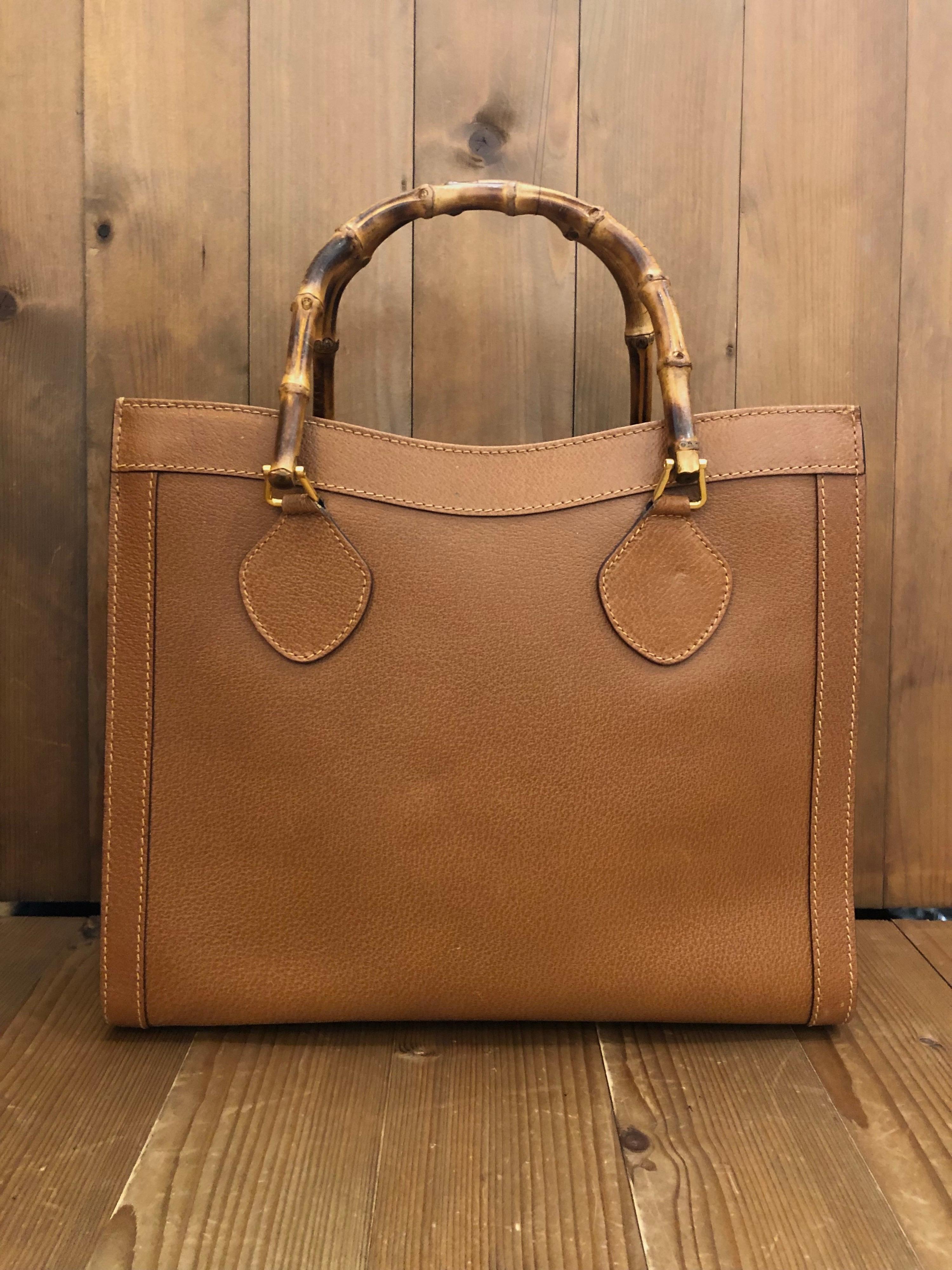 1990s Gucci bamboo tote in brown leather. The Bamboo tote is one of Princess Diana's favorite purses. Gucci revamped this Bamboo tote in 2021 winter collection. Made in Italy. Measures 13 x 11 x 5.5 inches handle drop 5 inches. It features two main