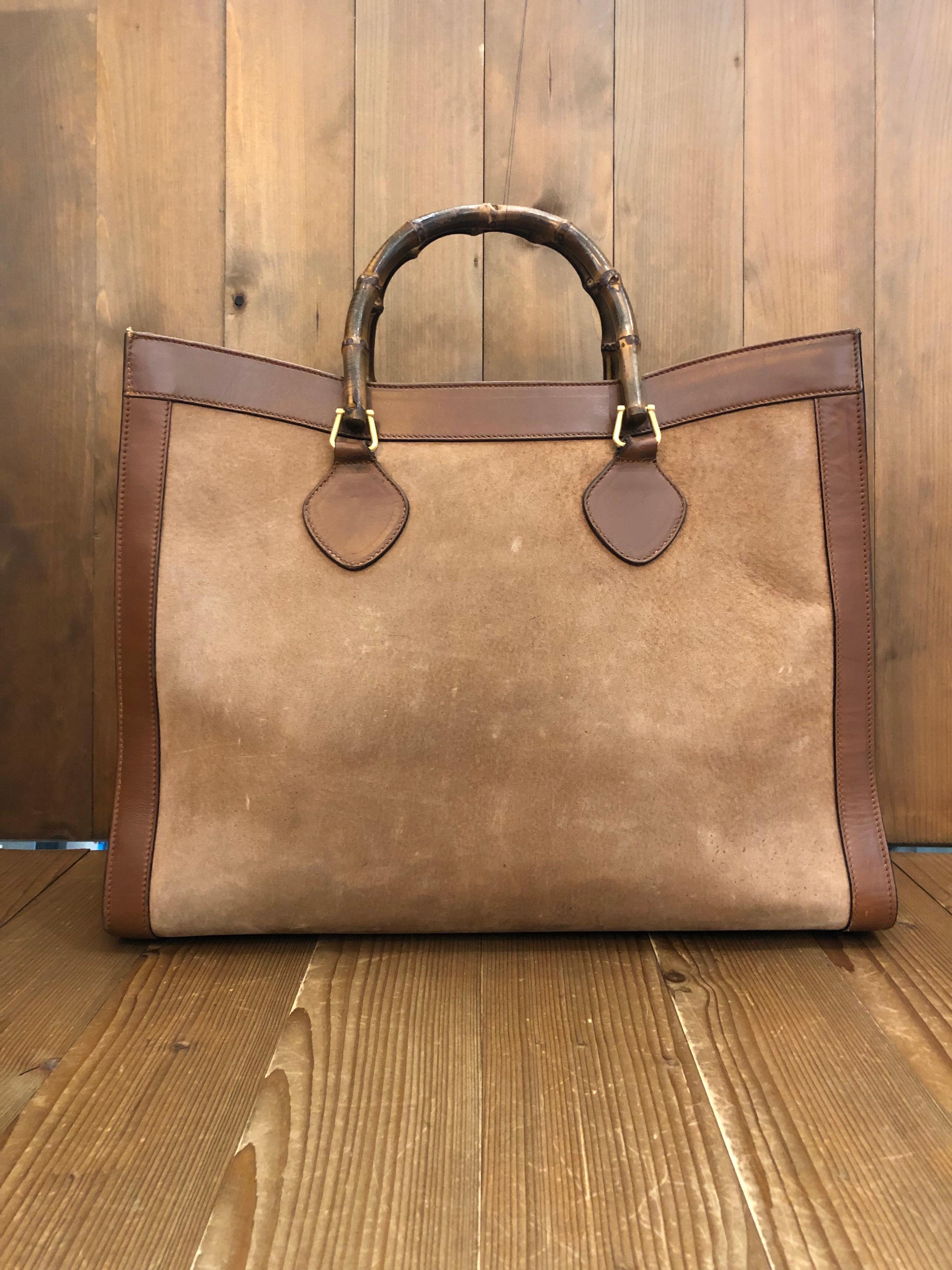 This large 1990s Gucci Diana bamboo tote is crafted of brown suede and leather. The Bamboo tote is one of Princess Diana's favorite purses. This Gucci bamboo tote features one very spacious interior and one zippered pocket. Gucci revamped this